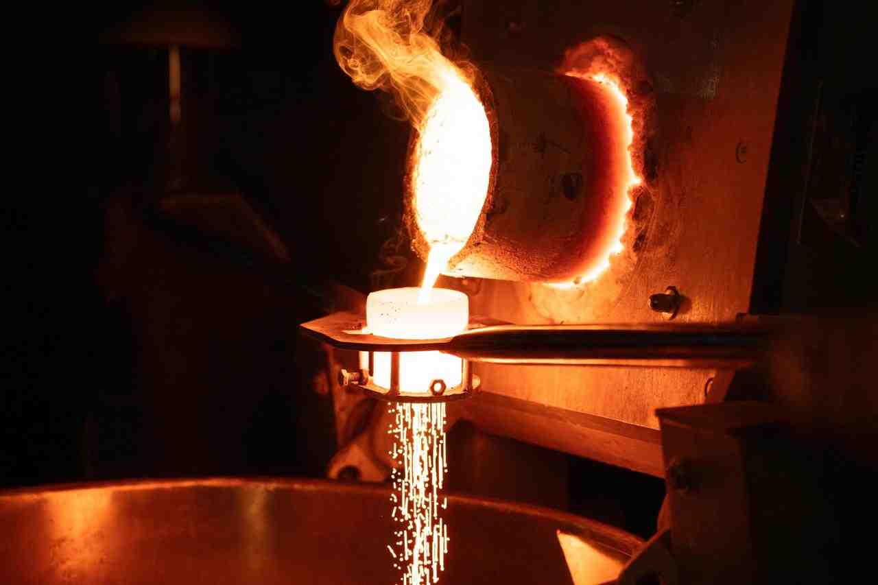 Molten metal being poured in minting process