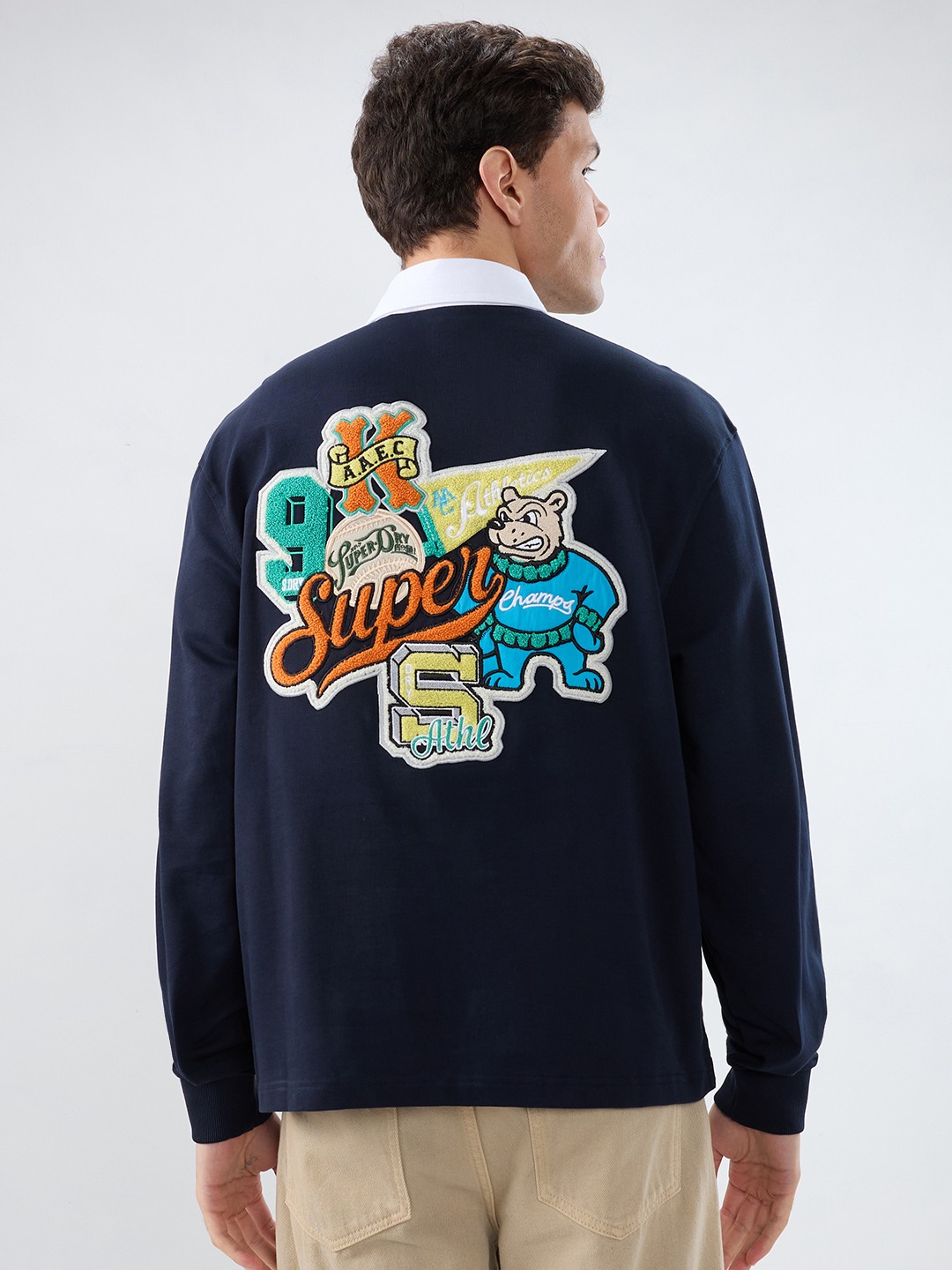 VARSITY PREP MULTI BADGE POLO STYLE