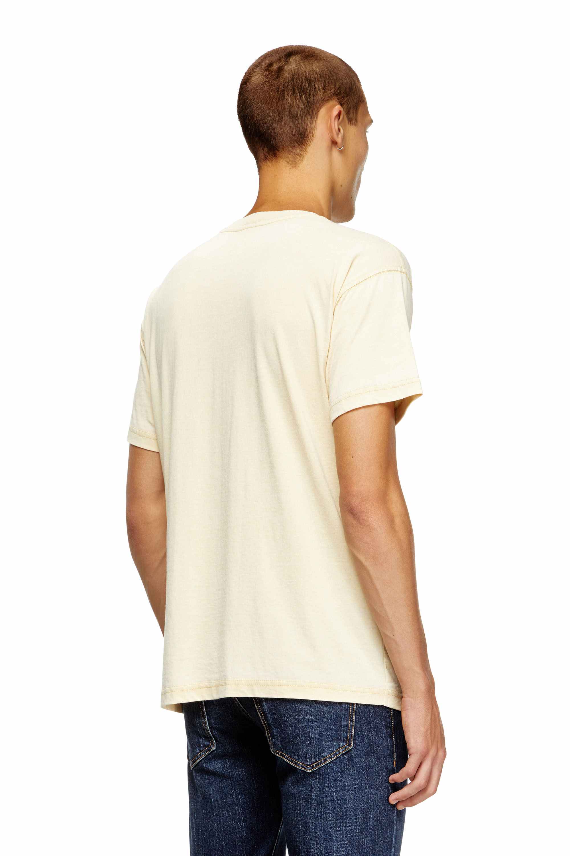 Beige T-shirt with rhinestone graphic