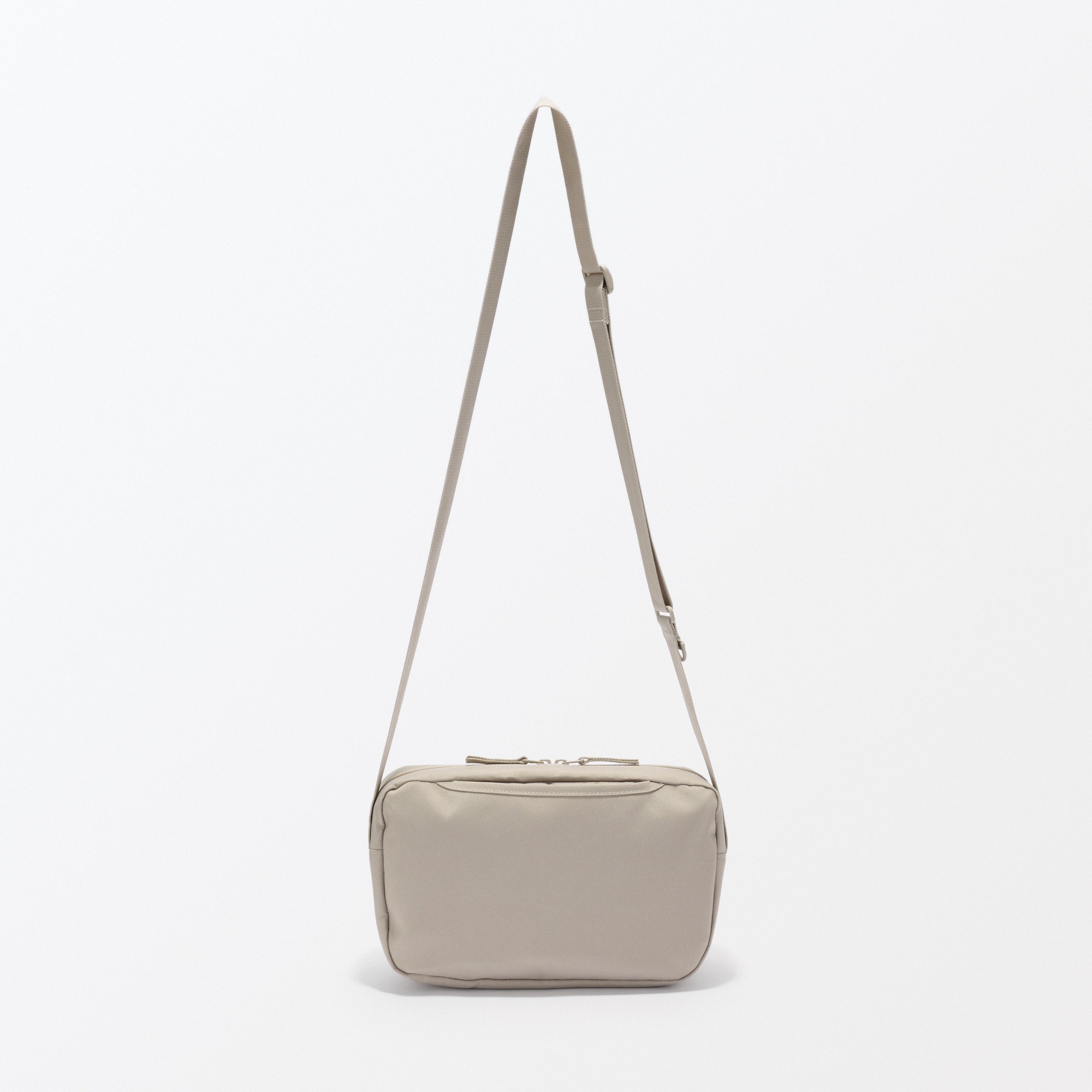 Water repellent shoulder bag with back pocket