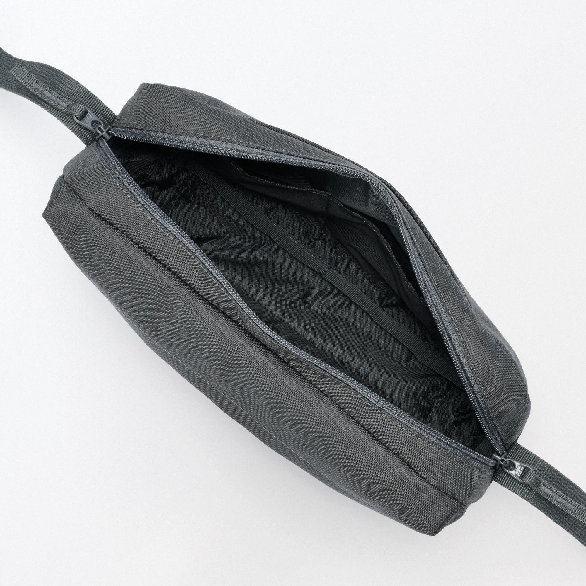 Water repellent shoulder bag with back pocket