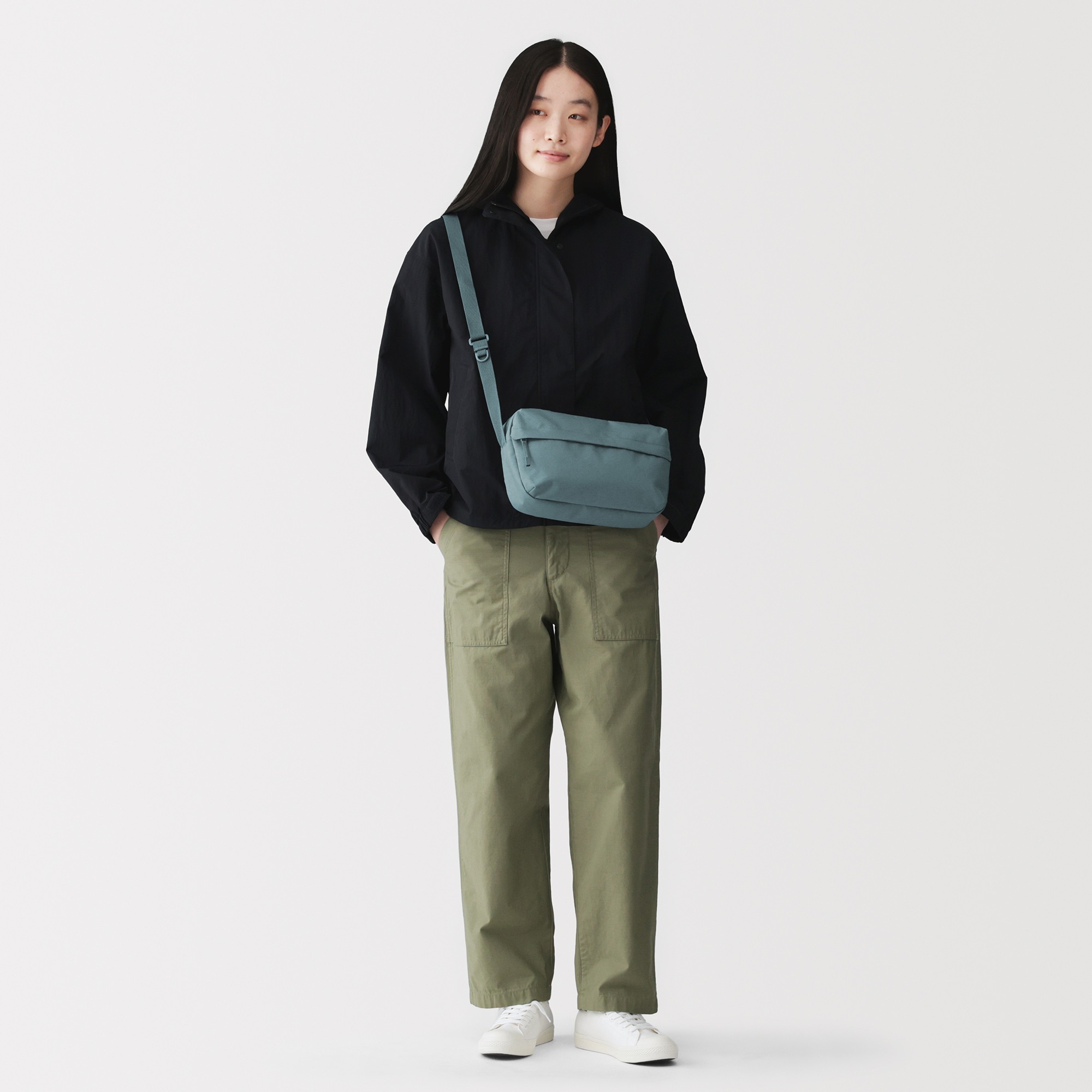 Water repellent shoulder bag with back pocket