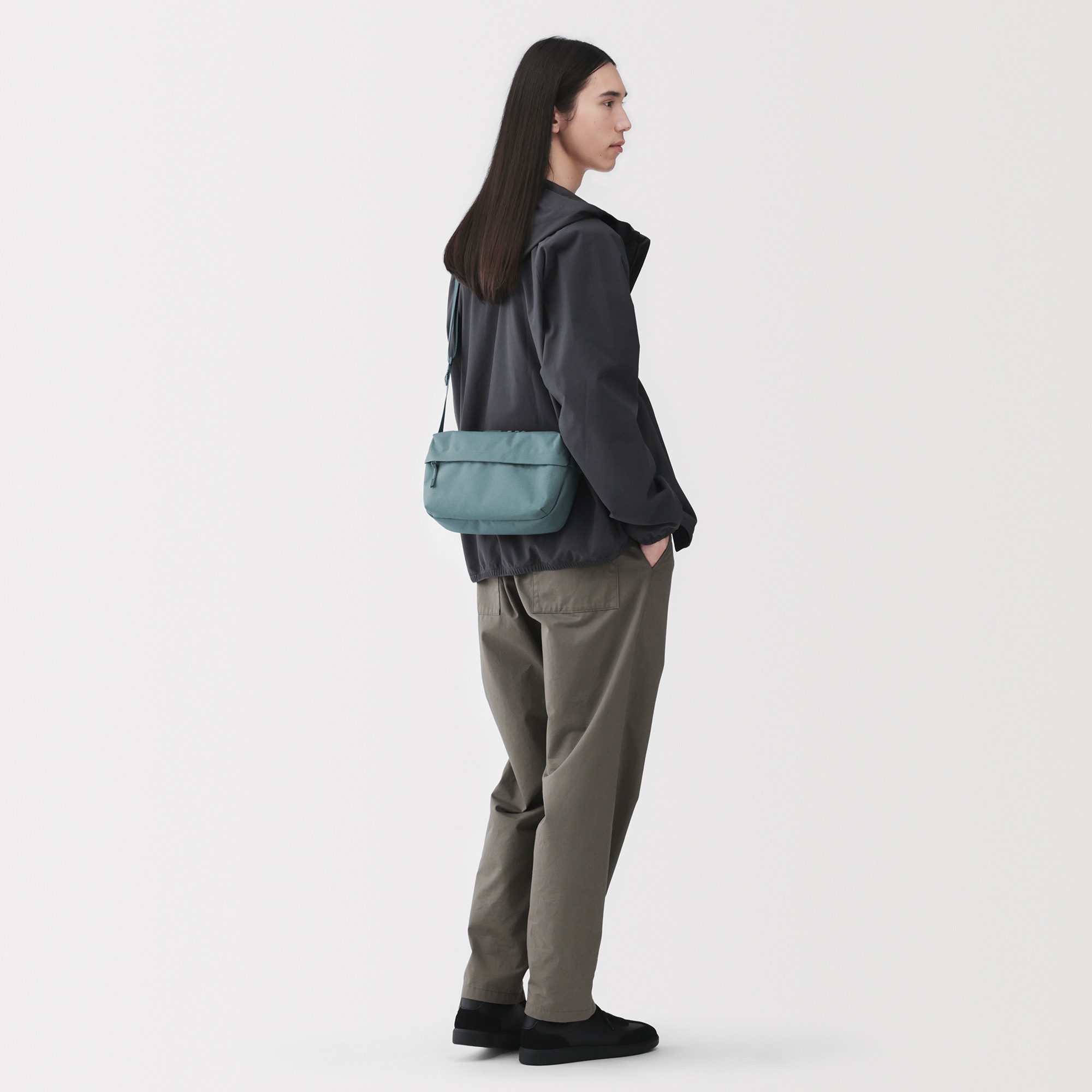 Water repellent shoulder bag with back pocket