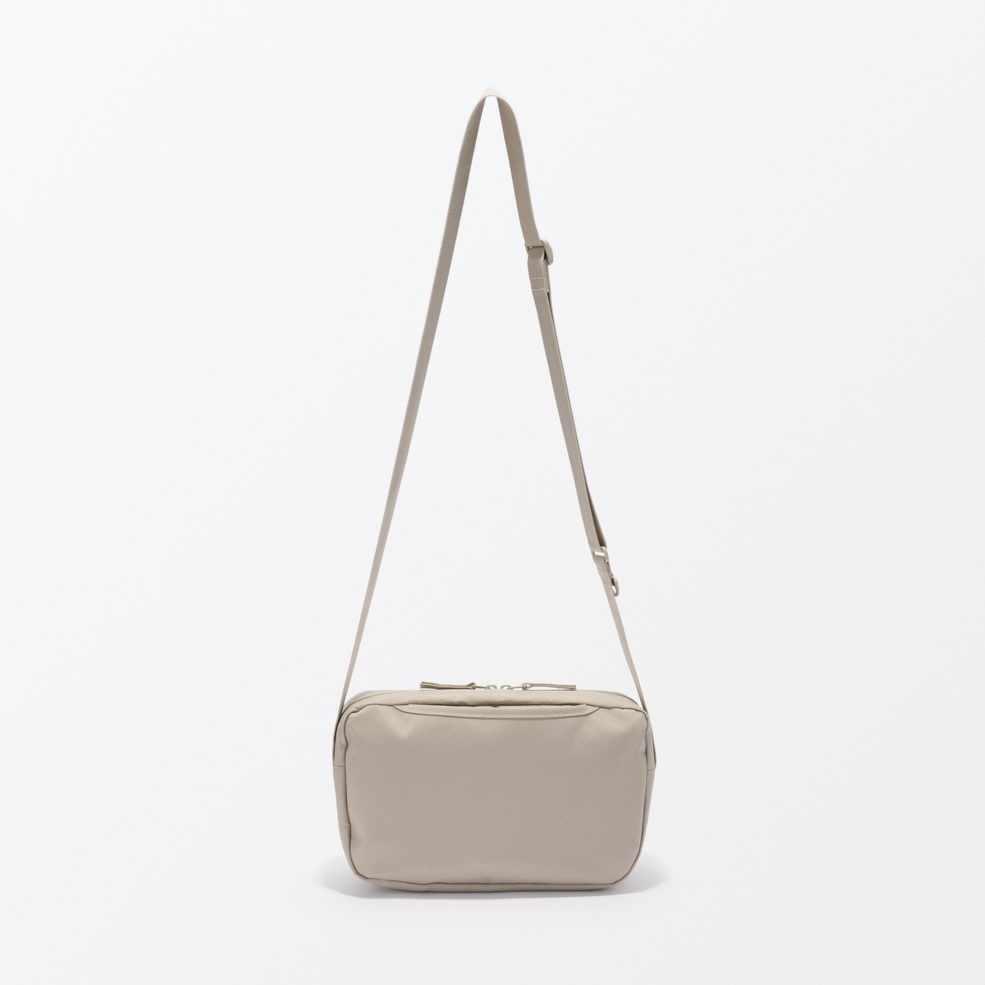 Water repellent shoulder bag with back pocket