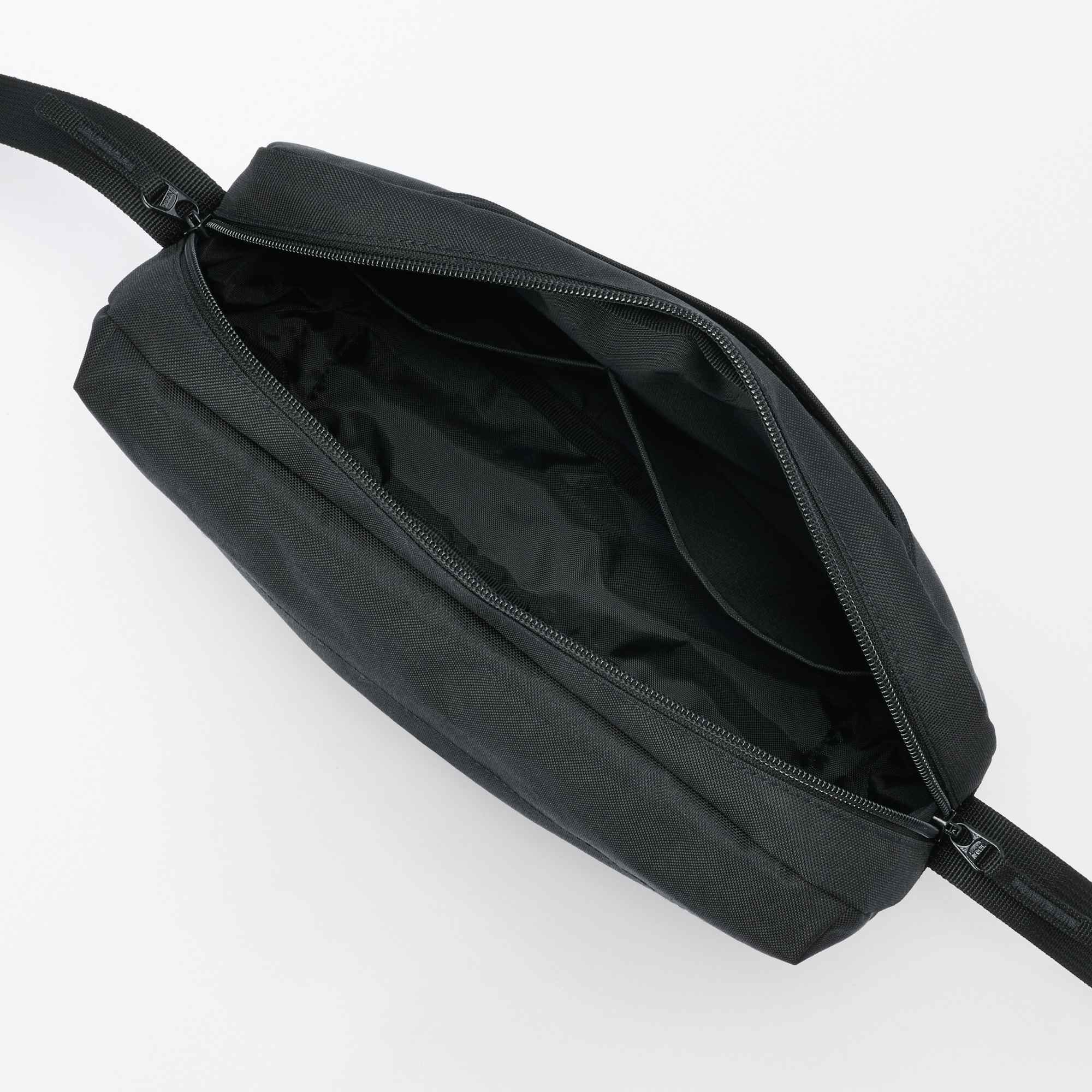Water repellent shoulder bag with back pocket