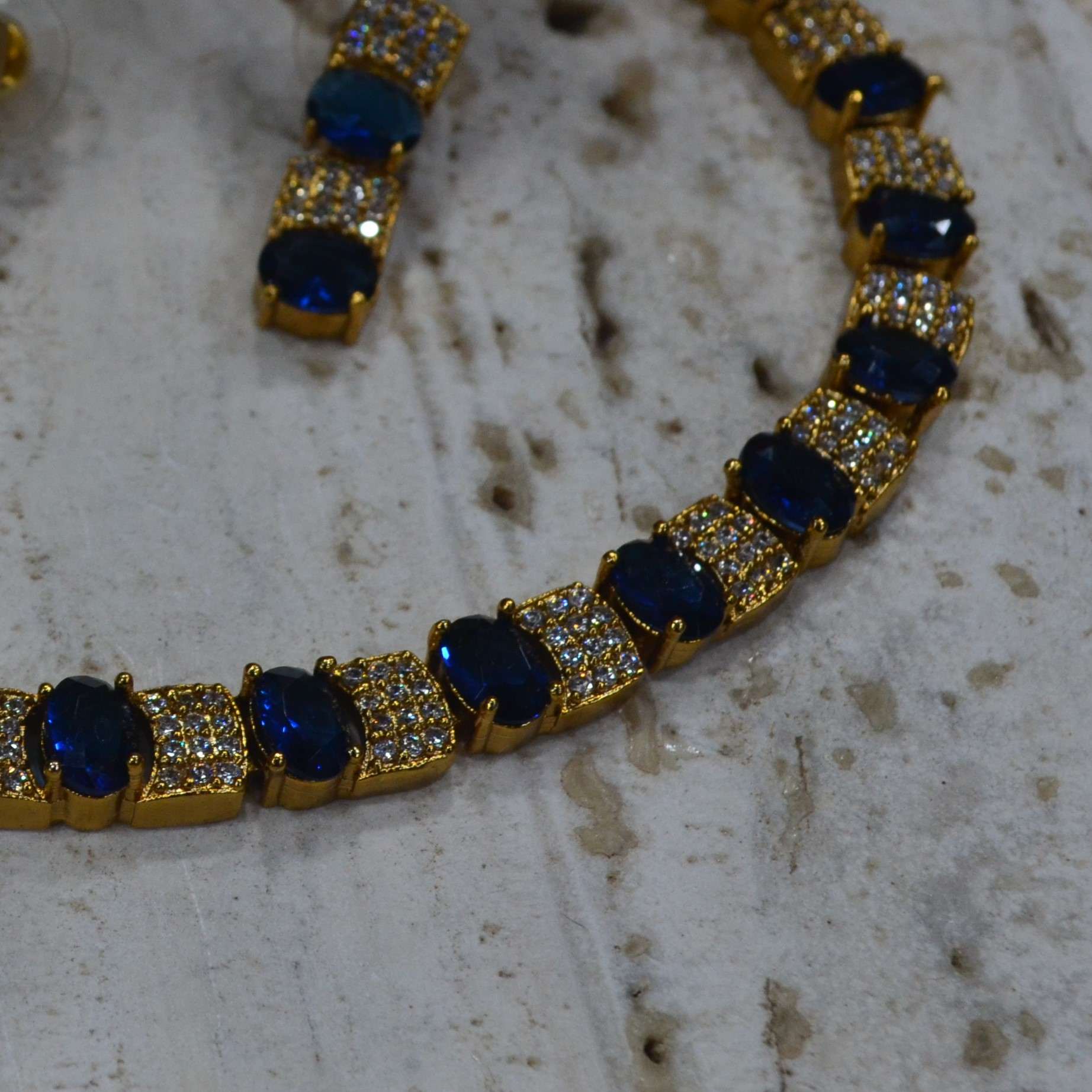 The Nila Gold Plated Crystal and Blue Sapphire Studded Choker with Drop Earnings