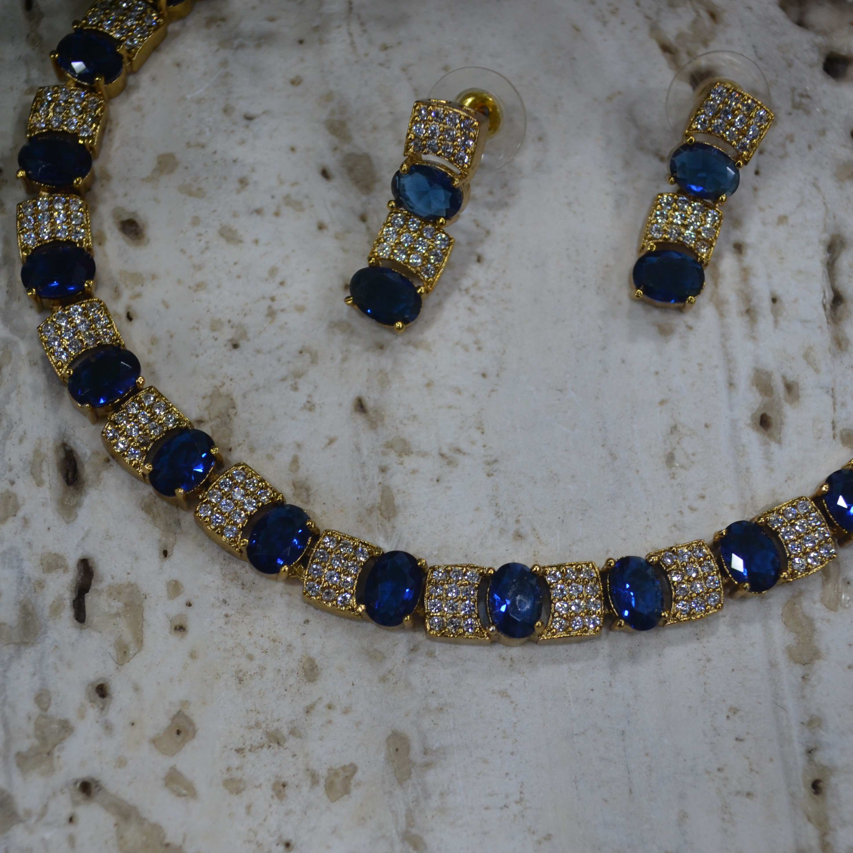 The Nila Gold Plated Crystal and Blue Sapphire Studded Choker with Drop Earnings