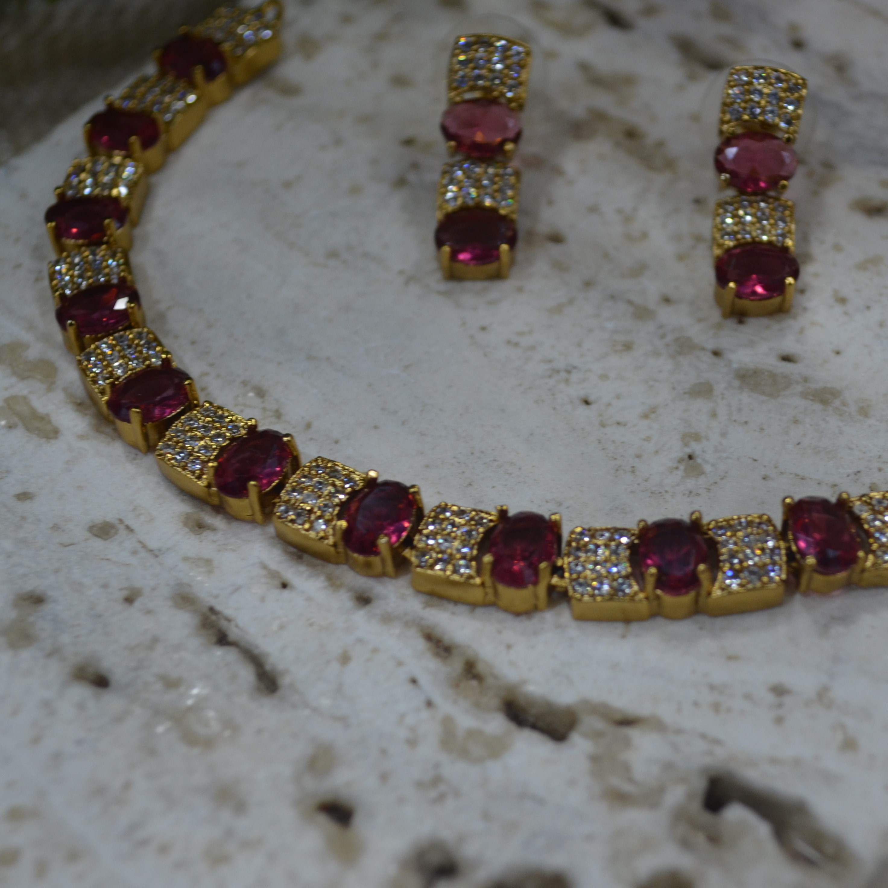 The Nila Gold Plated Crystal and Ruby Sapphire Studded Choker with Drop Earnings