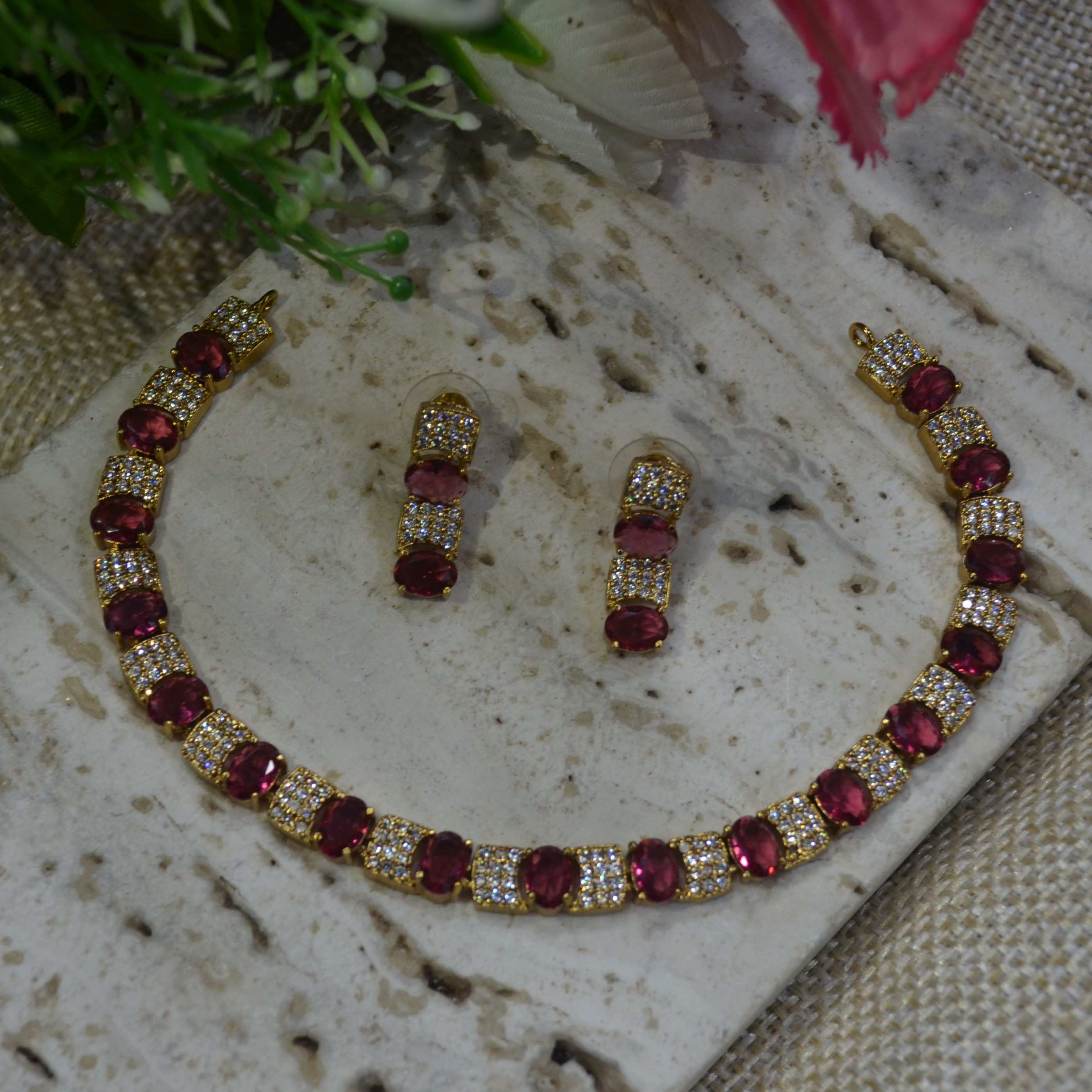 The Nila Gold Plated Crystal and Ruby Sapphire Studded Choker with Drop Earnings