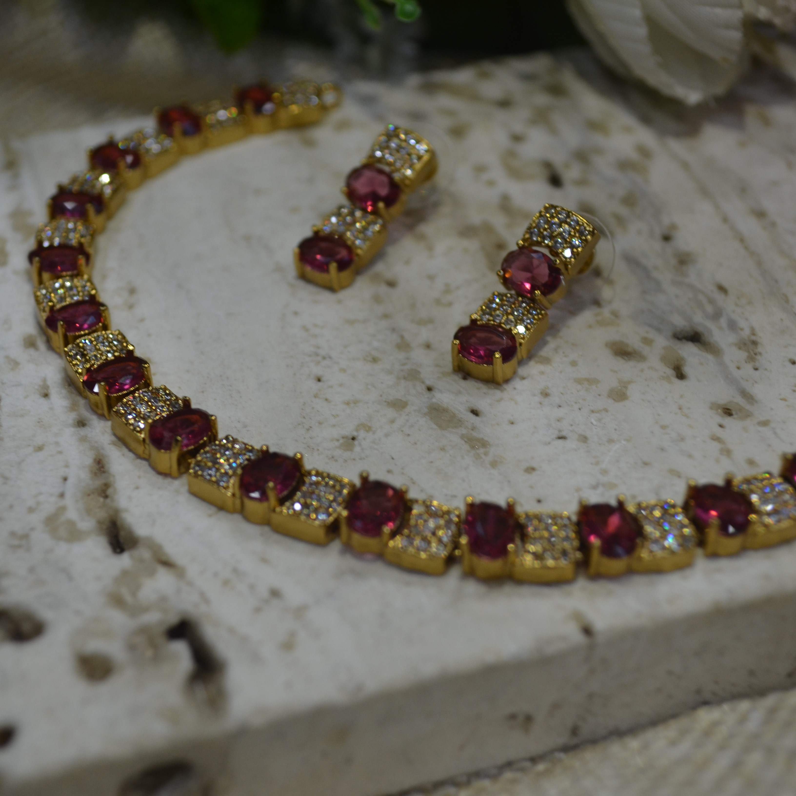 The Nila Gold Plated Crystal and Ruby Sapphire Studded Choker with Drop Earnings