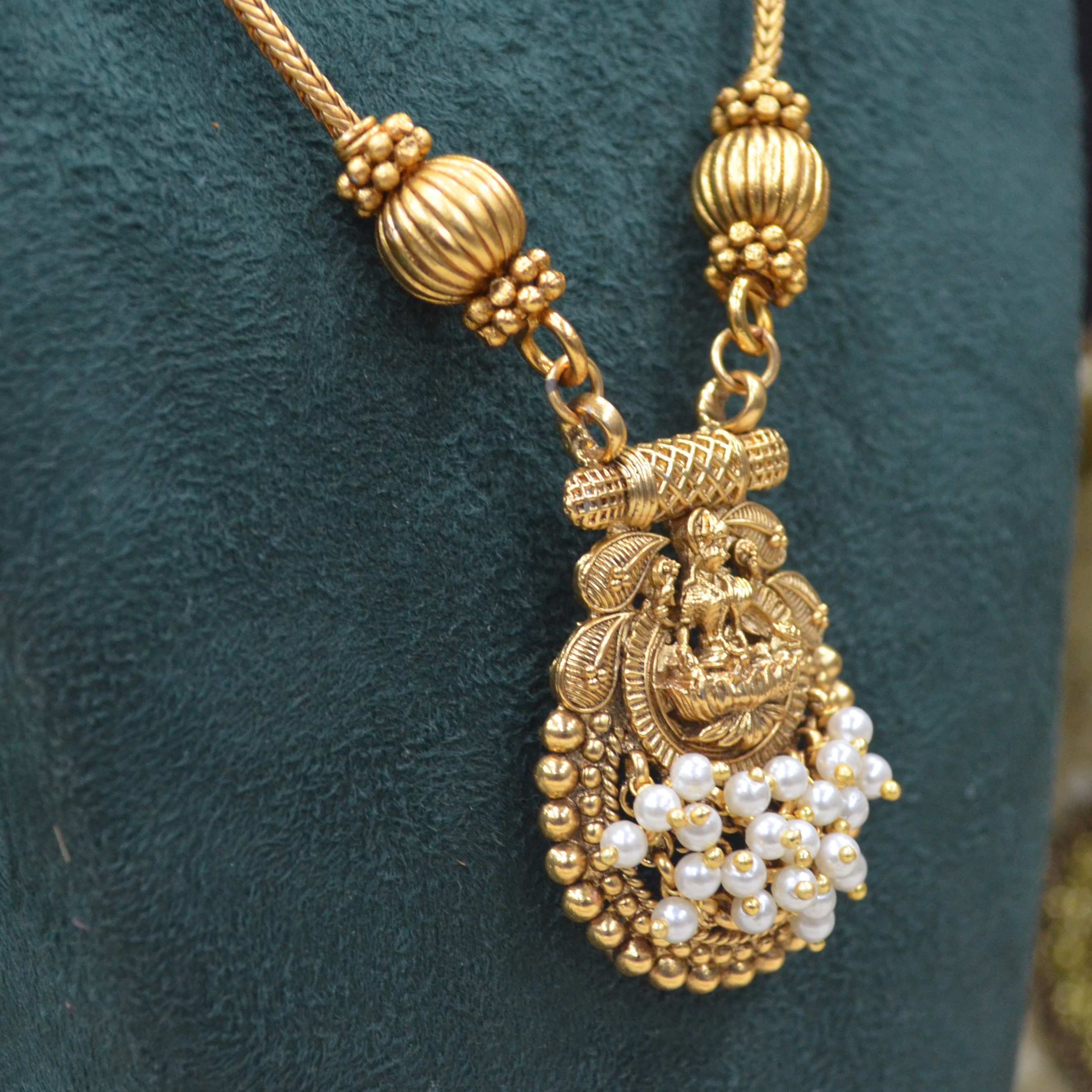 The Nila Gold Plated Temple Design Pendant Chain with Pearl Tops Earrings