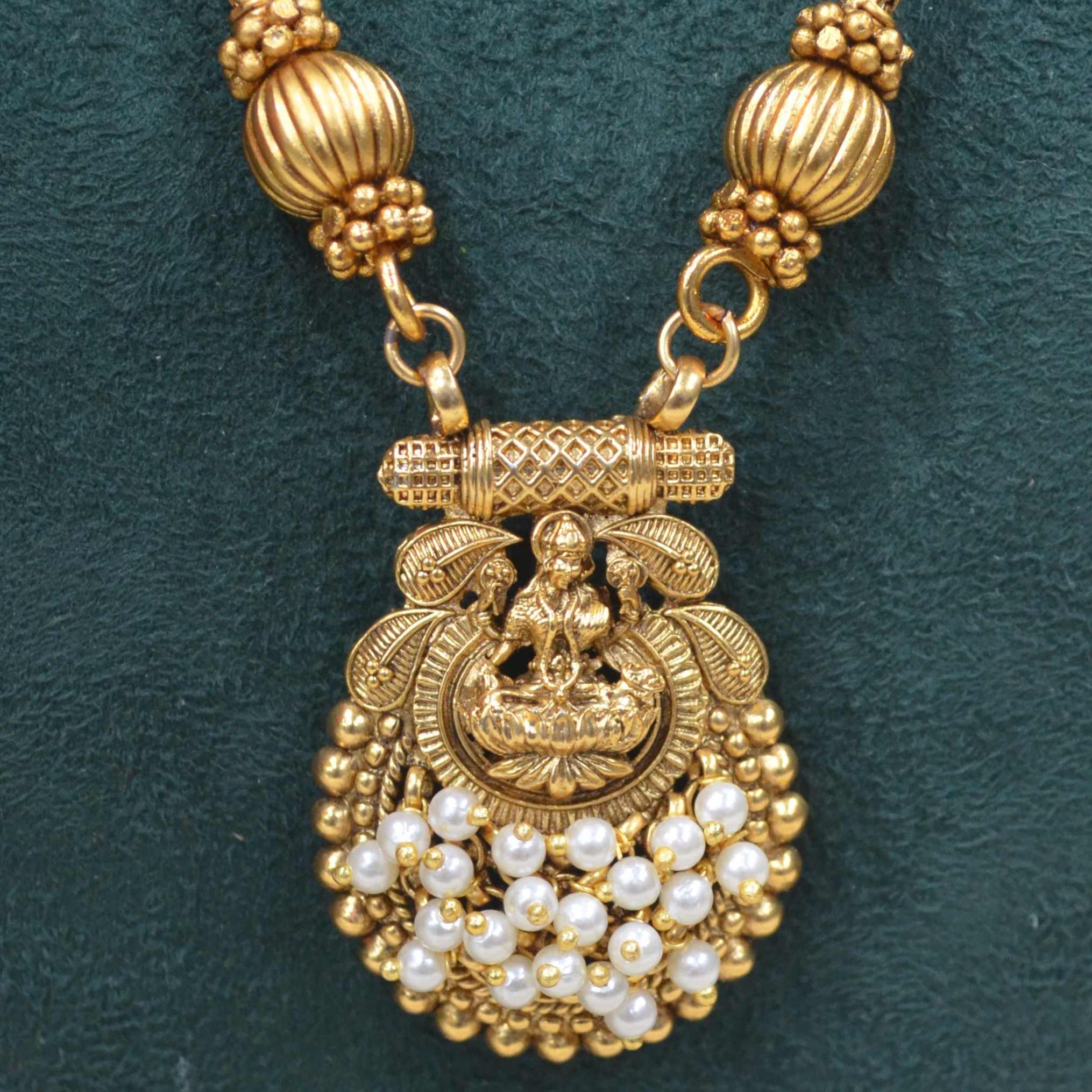 The Nila Gold Plated Temple Design Pendant Chain with Pearl Tops Earrings