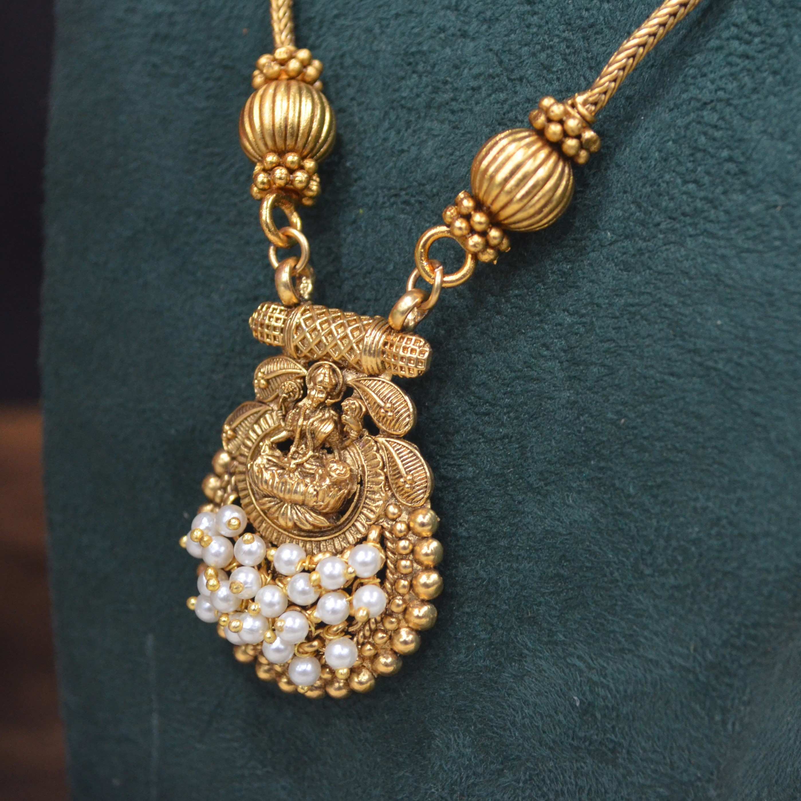 The Nila Gold Plated Temple Design Pendant Chain with Pearl Tops Earrings