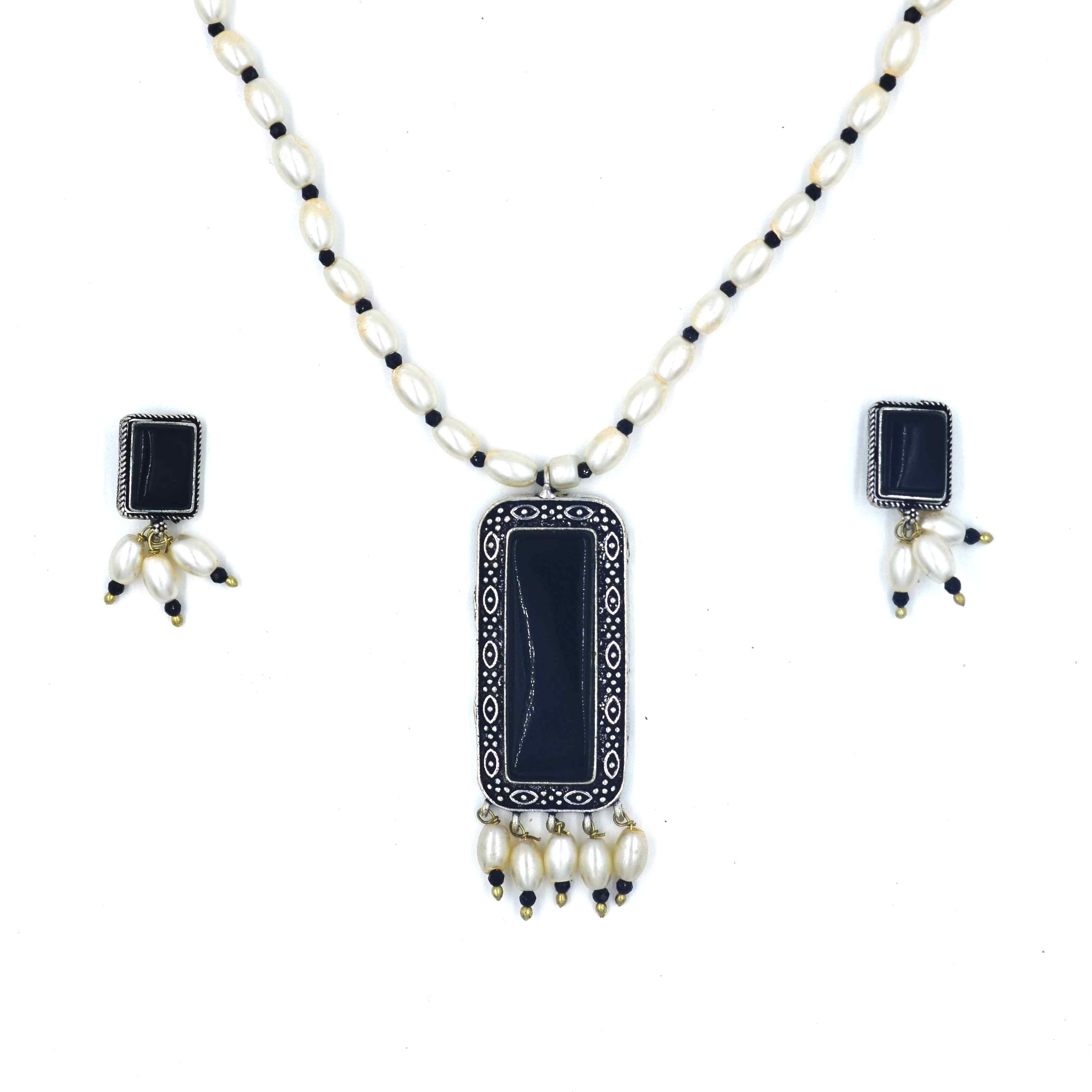 The Nila Silver Oxidized Black Pendant with Pearl chain and Top Earrings