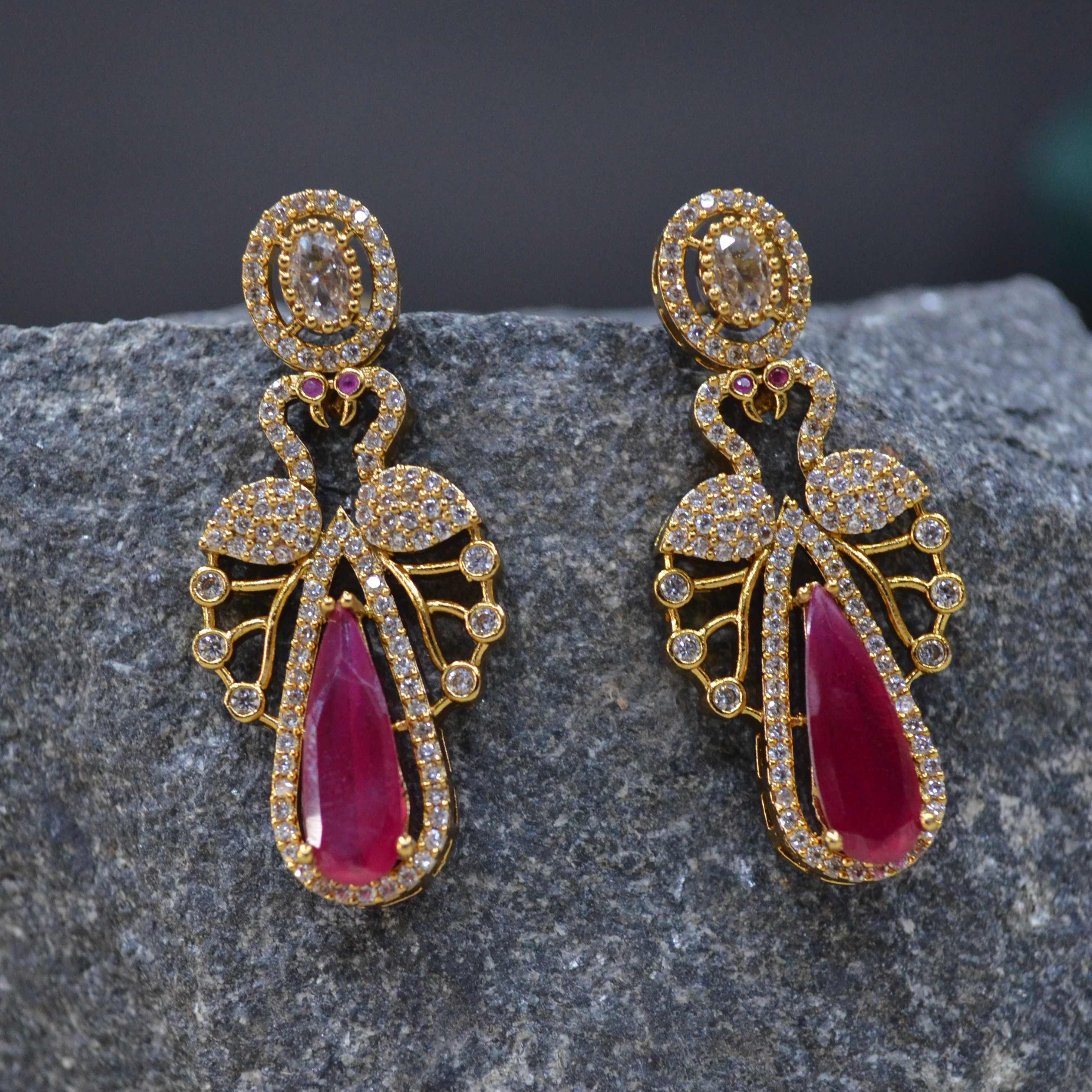 The Nila Gold Plated Peacock Design Crystal Necklace with Teardrop Ruby Drop Earrings