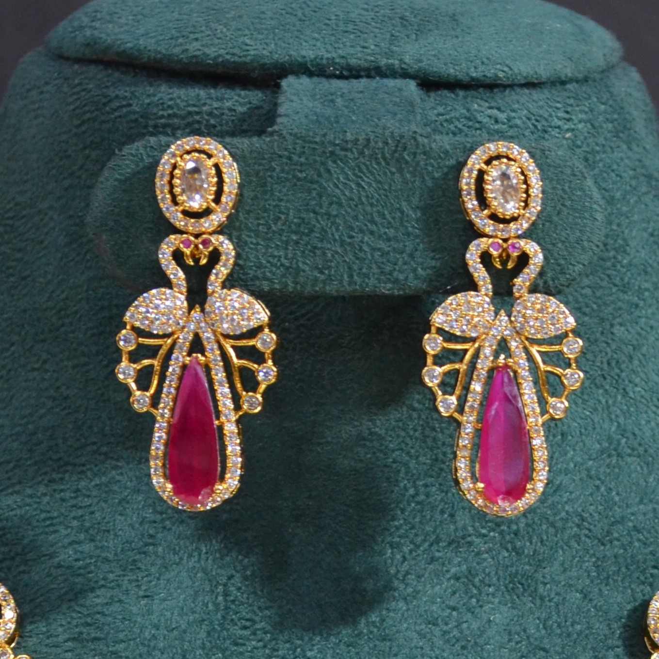 The Nila Gold Plated Peacock Design Crystal Necklace with Teardrop Ruby Drop Earrings