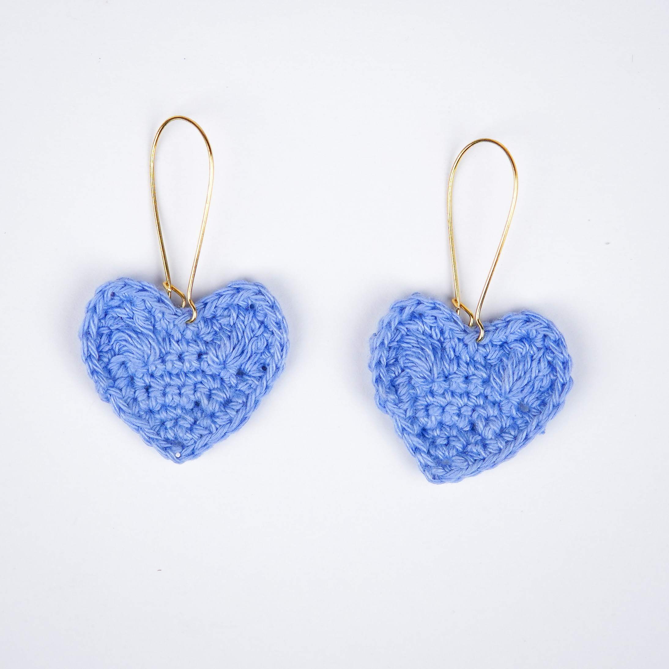 Close-up of the Asmaani blue shade and the intricate crochet details of the heart earrings