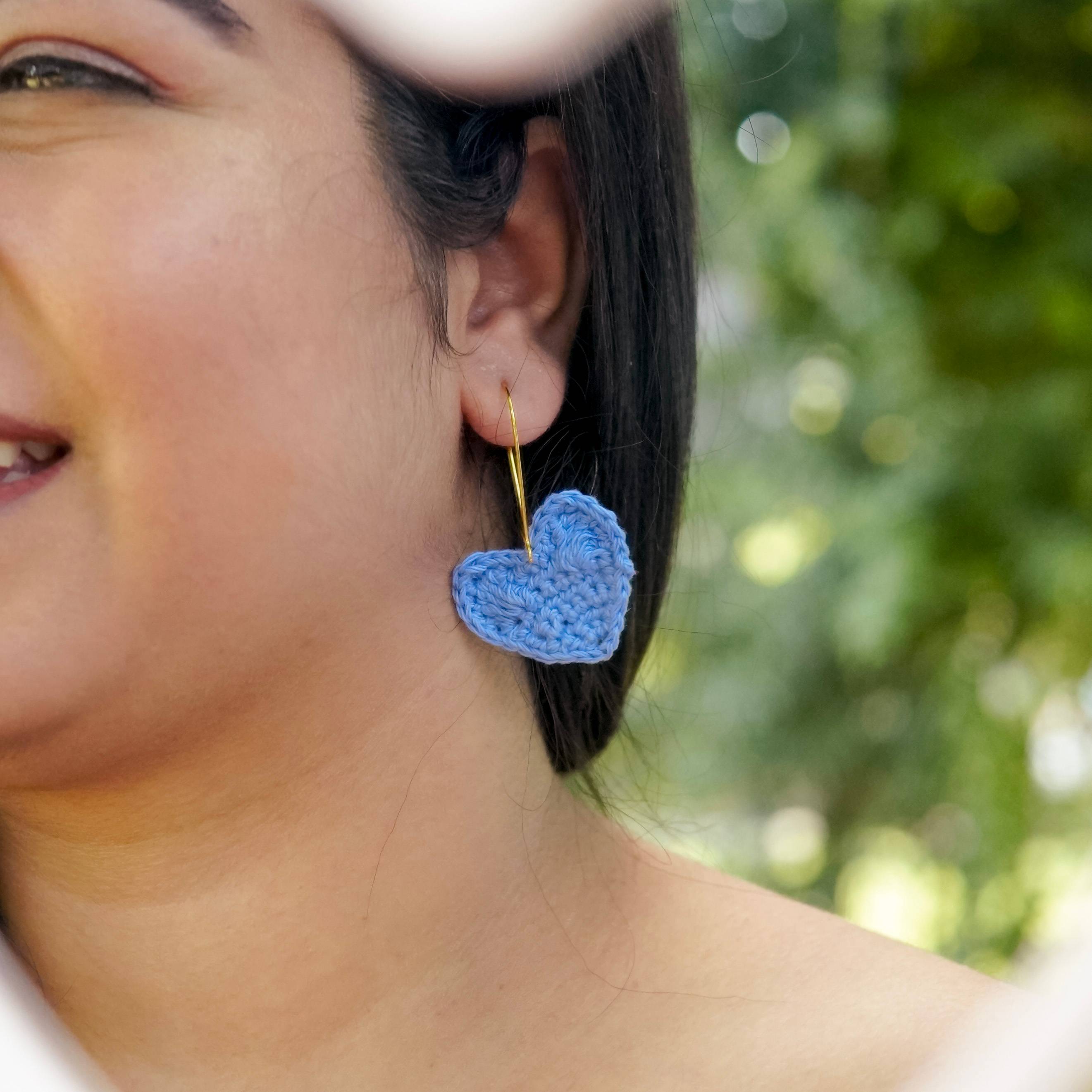  Model wearing Asmaani Blue Crochet Heart Earrings, adding a touch of celestial charm to the outfit.