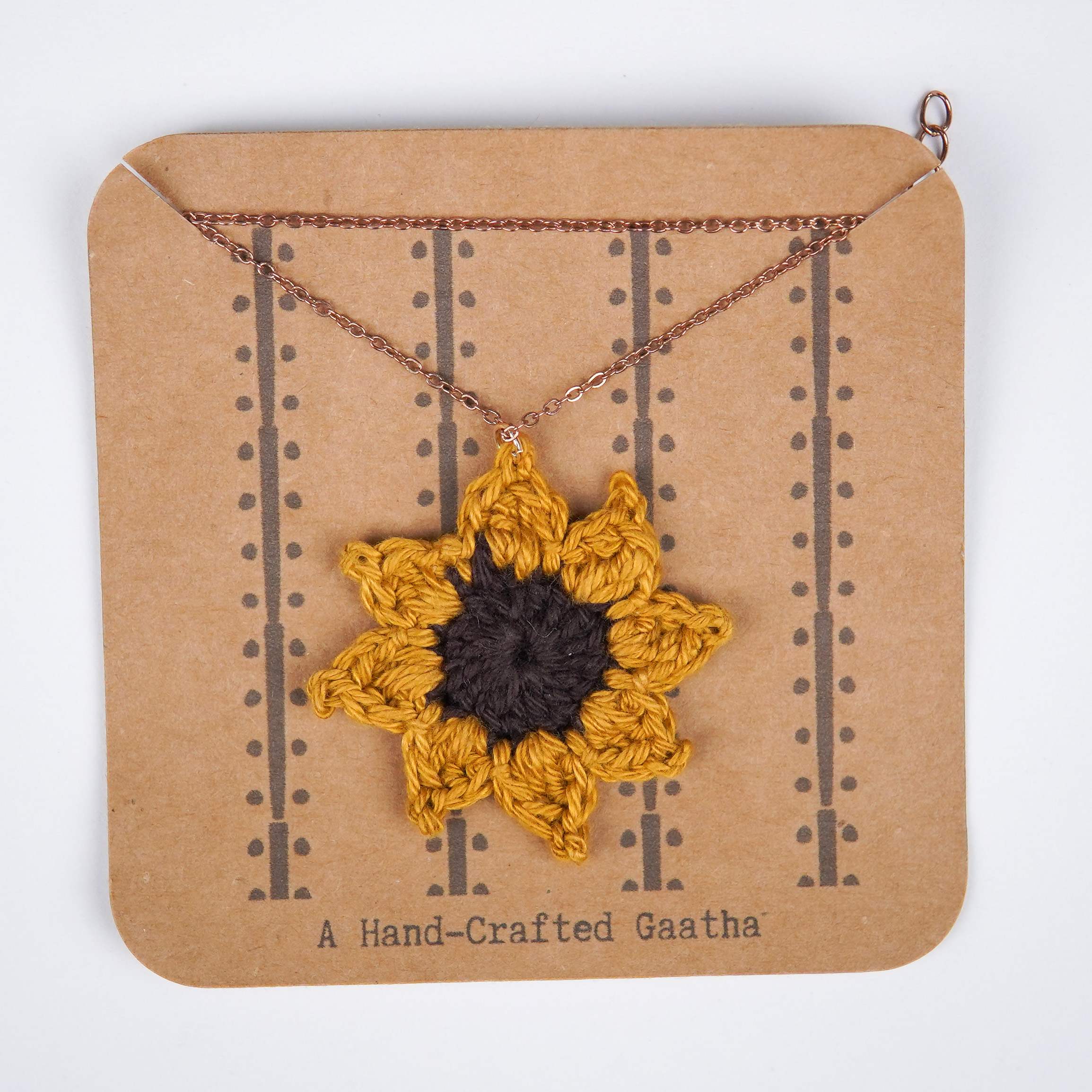 Close-up of AHG's Sunflower Pendant. Delicate details capture the beauty of nature.