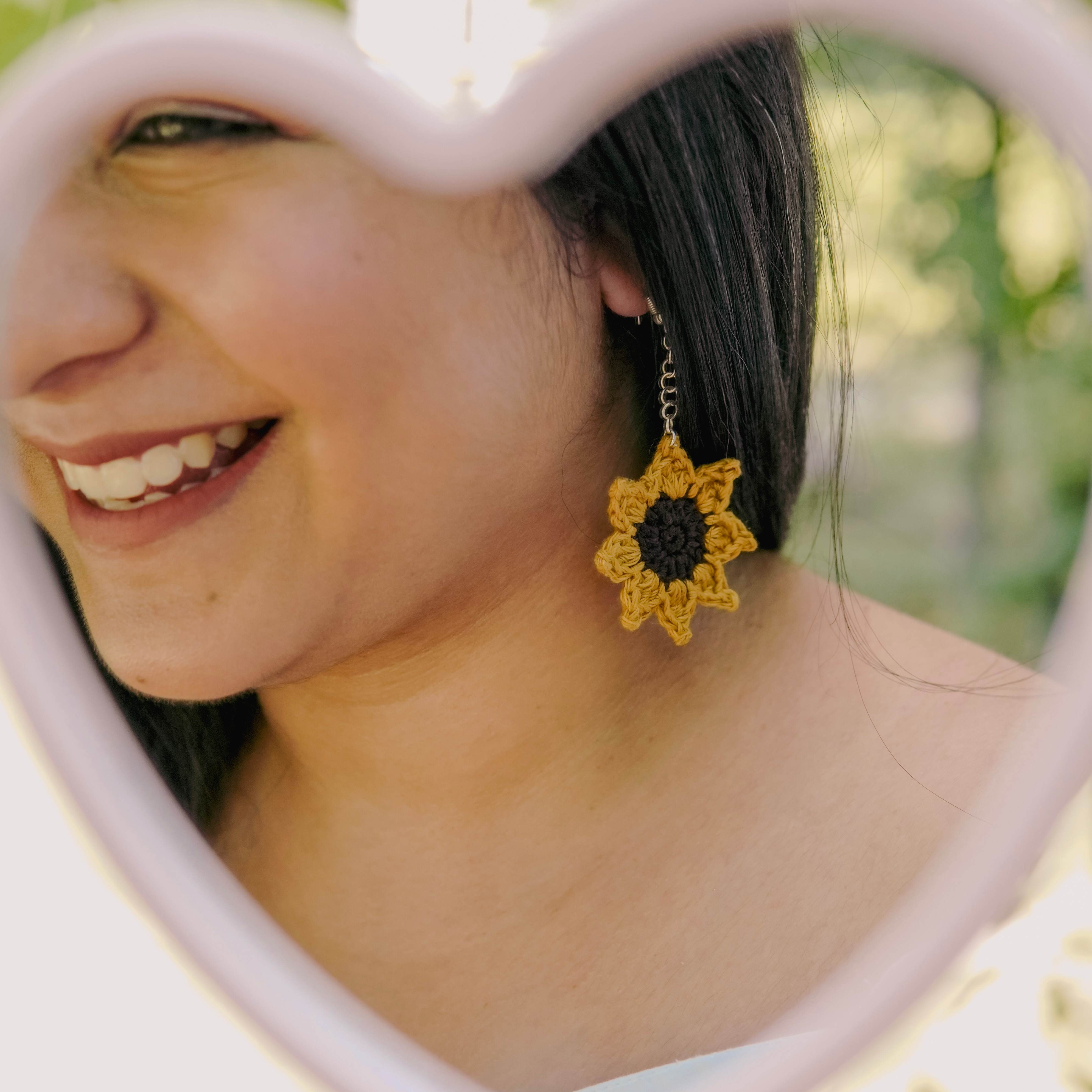 Model wearing the Sunflower Crochet Earrings by AHG. Perfect for summer vibes!