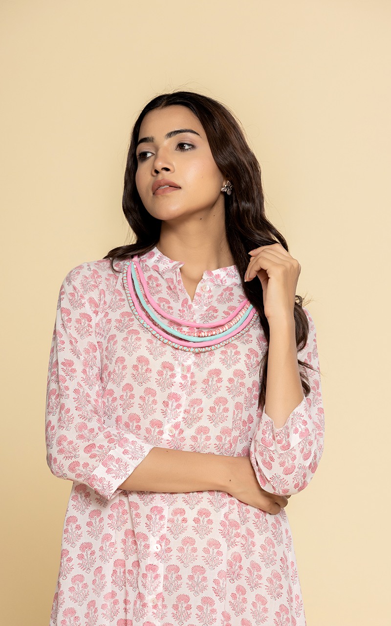 Block printed pink dress with a neckpiece