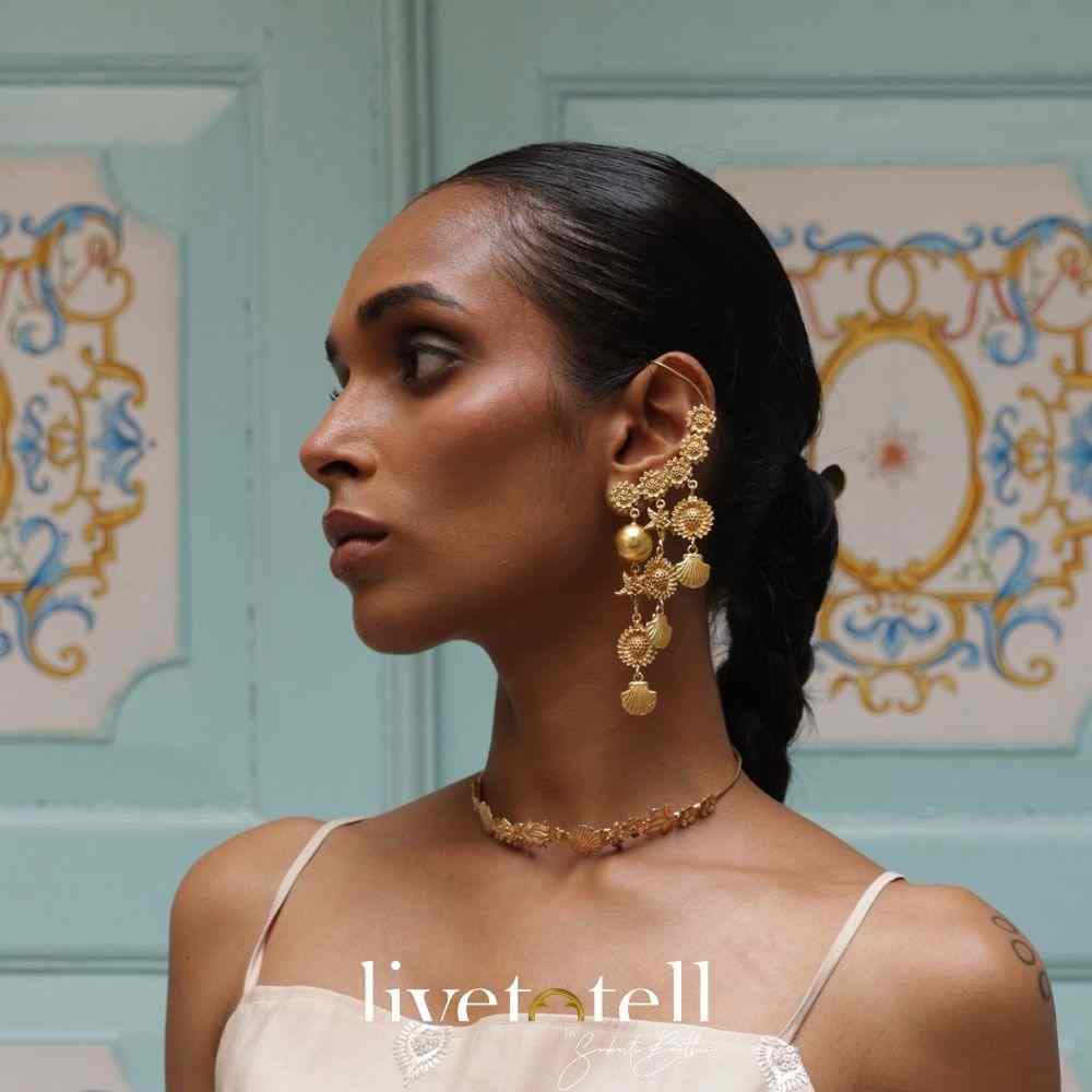 - Gold plated Jugni Pataka earcuffs with floral chaton detailing - Handcrafted earcuffs from Jaipur with cascading elements - Lightweight statement earrings in dual-wrap silhouette - Bold Indian ear jewellery for weddings and cocktail nights