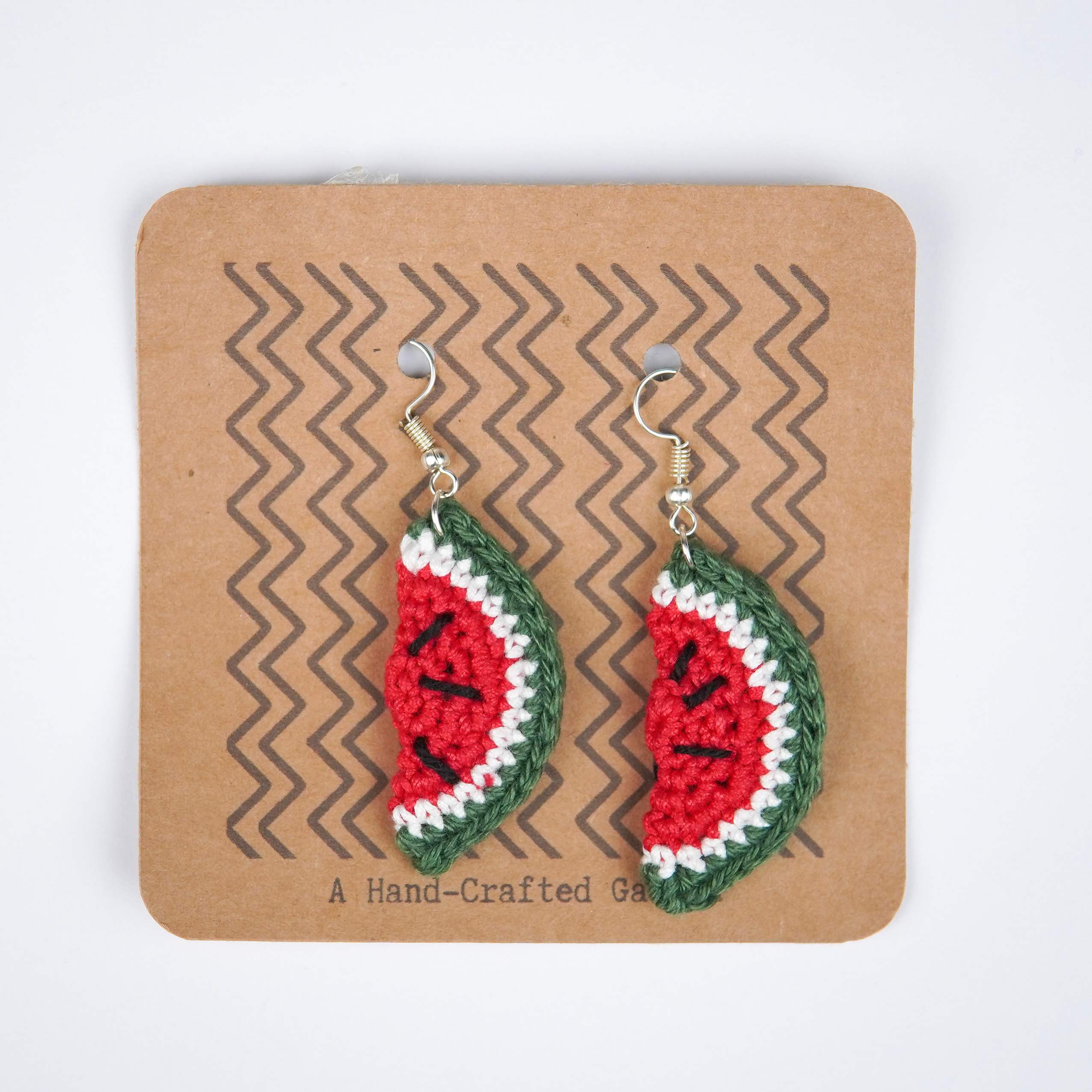 Close-up of AHG's Watermelon Earrings. Delicate details for a refreshing summer look.