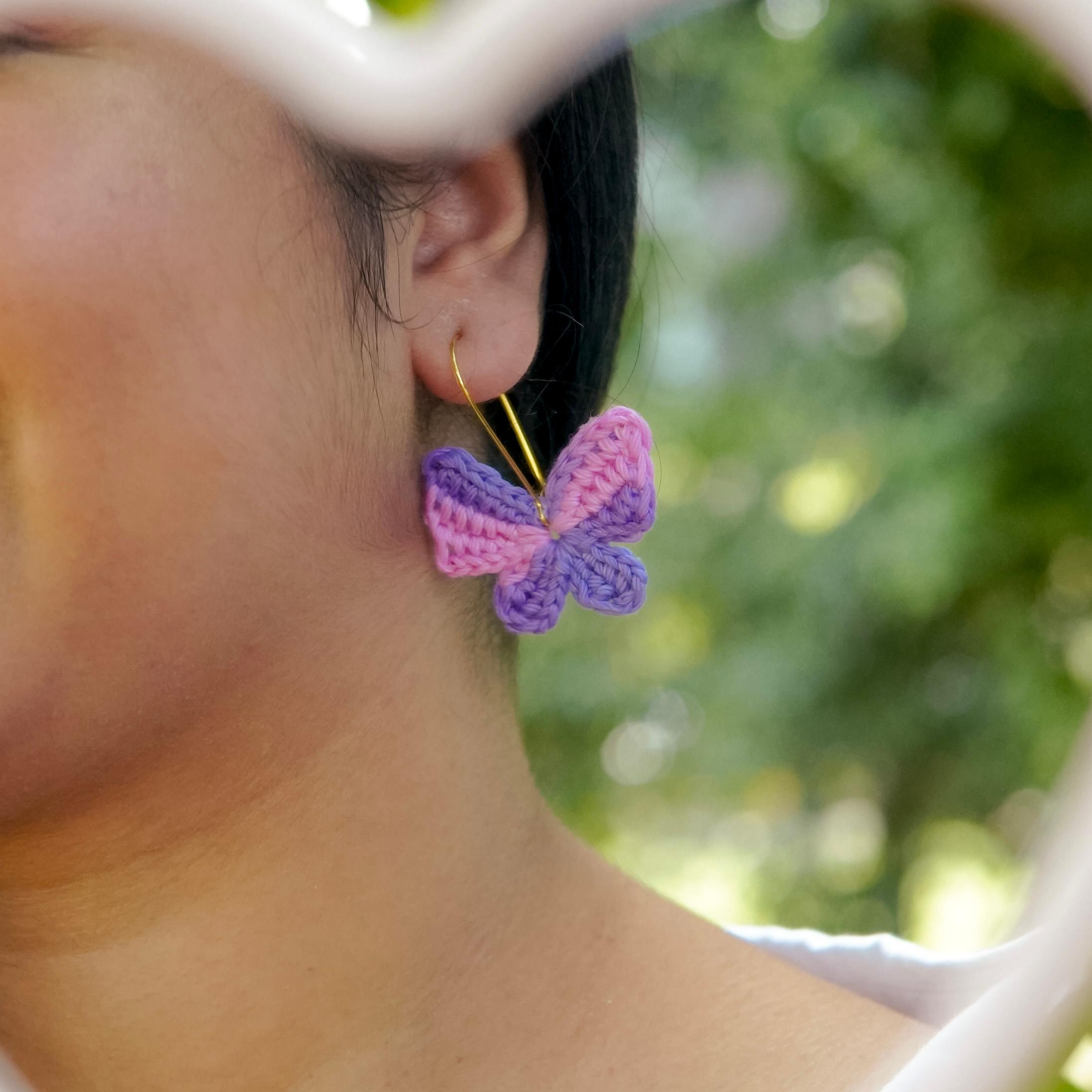 Model wearing the Pink & Purple Titli Crochet Earrings by A Handcrafted Gaatha, showcasing their playful elegance.