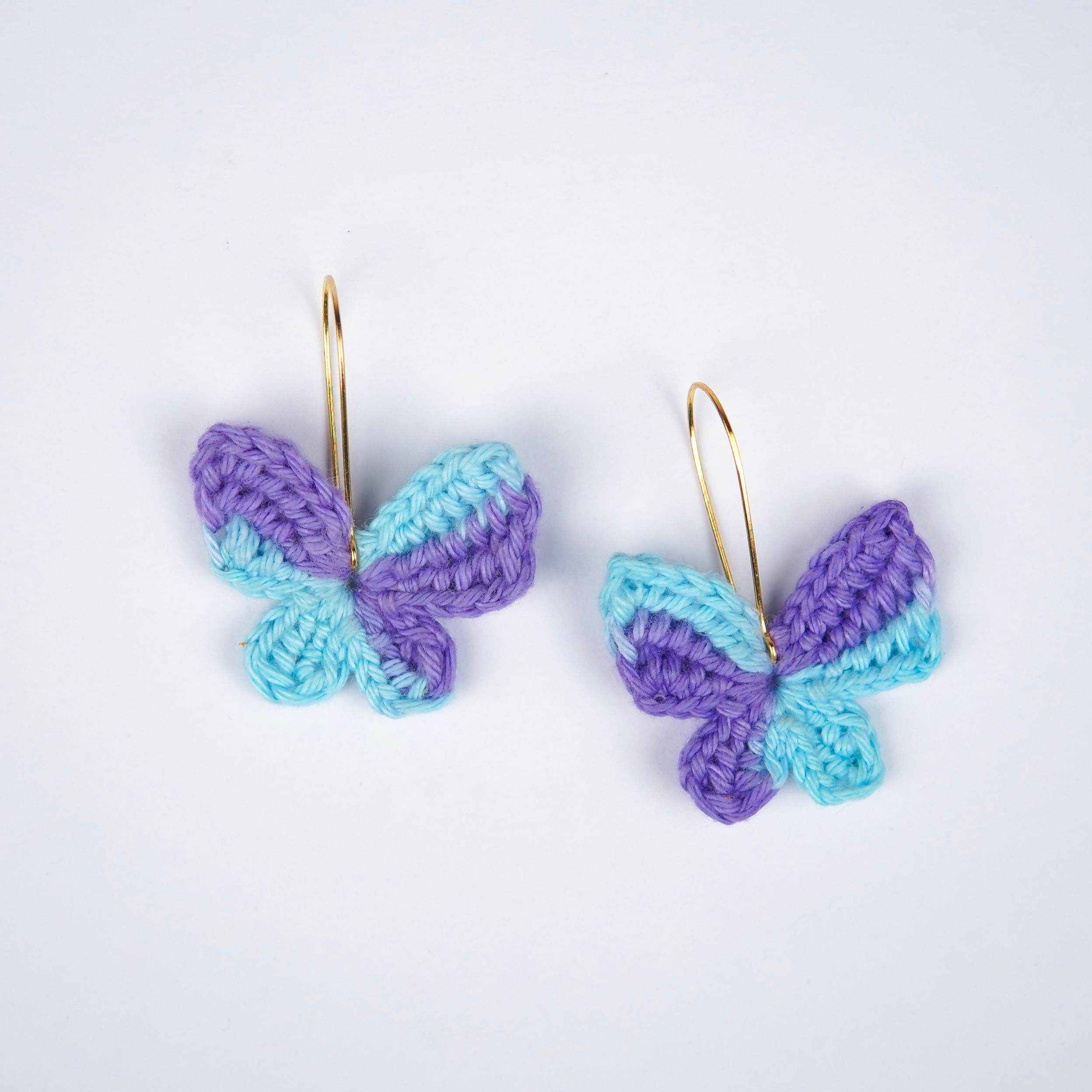 Close-up of the intricate crochet details and the captivating blue & purple shades of the titli earrings