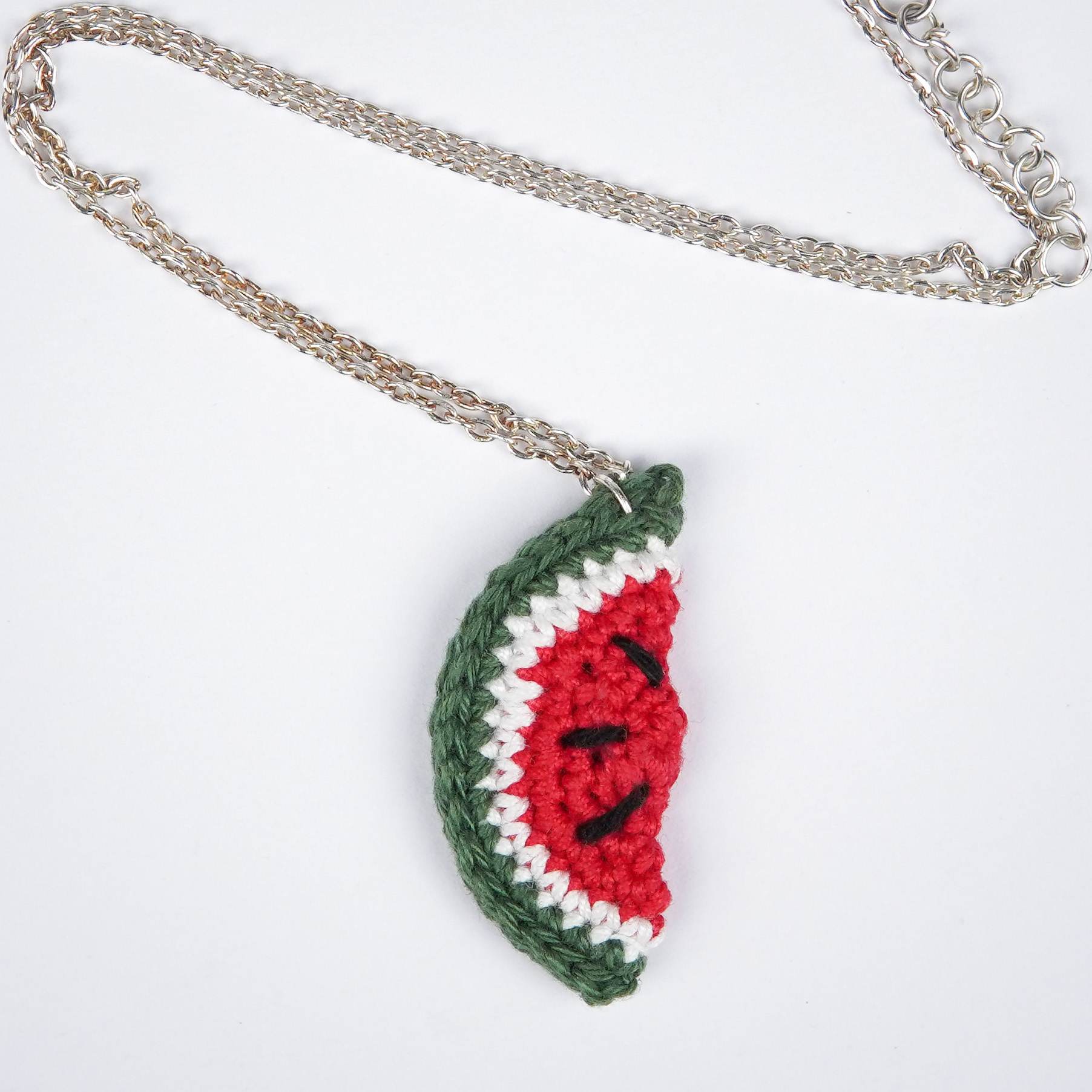 Close-up of AHG's Watermelon Pendant. Delicate details capture the sweetness of summer