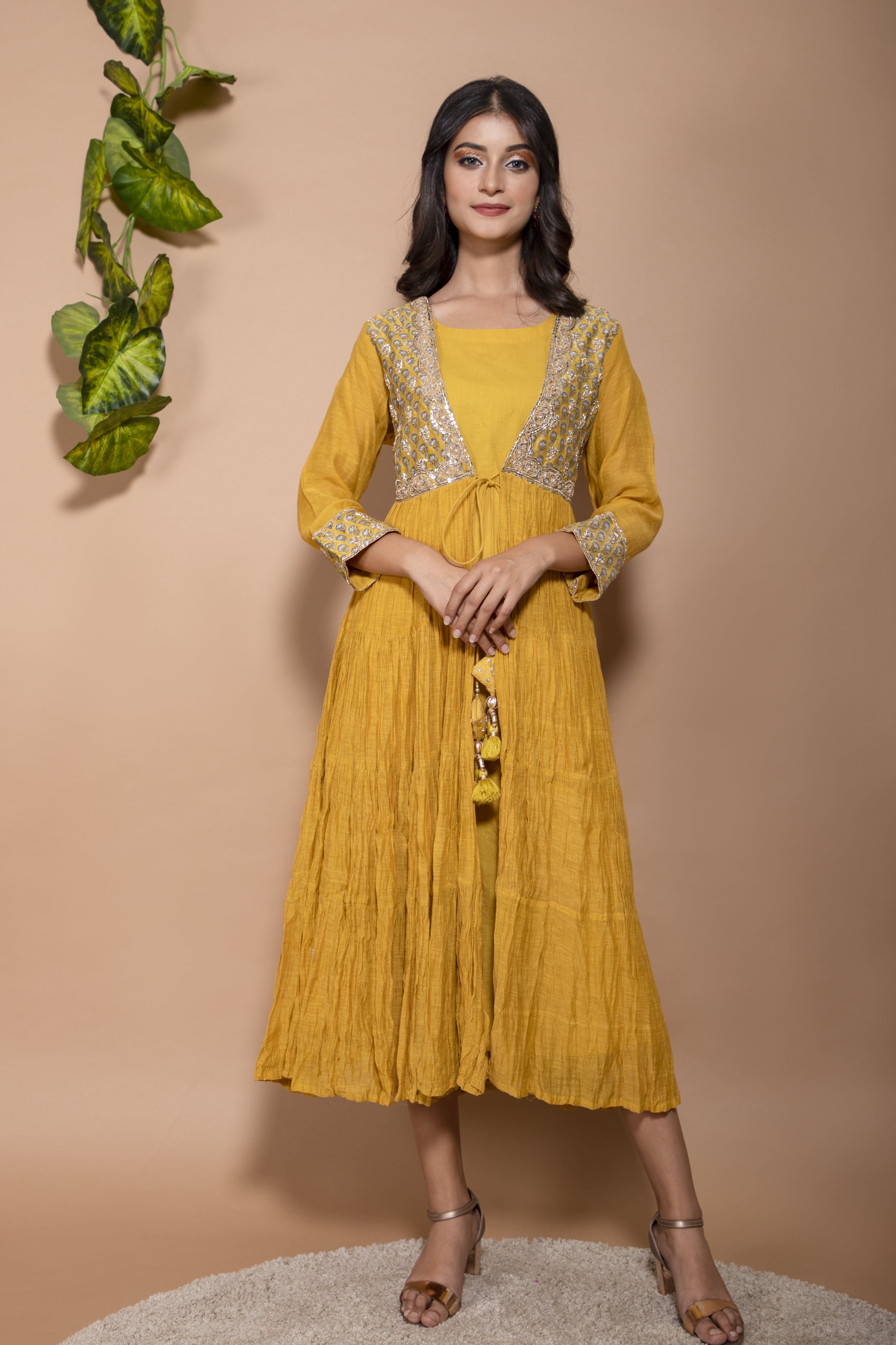 KAARAH BY KAAVYA | Chanderi jacket tiered anarkali with a printed yoke and hand work on the yoke and tassels in the front undefined