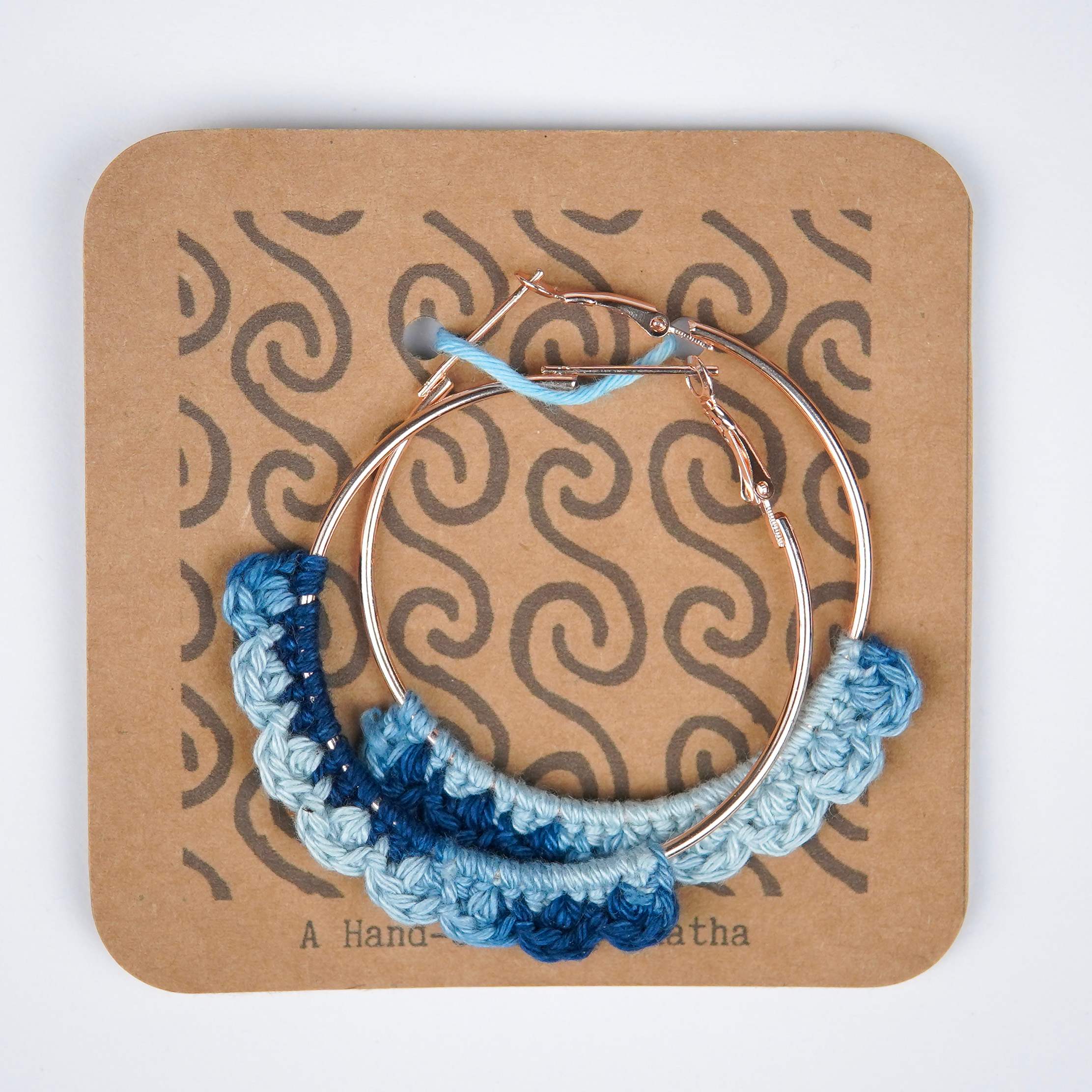 Close-up of AHG's Denim Blue Crochet Nazakat Hoops. Delicate crochet in a classic denim shade!