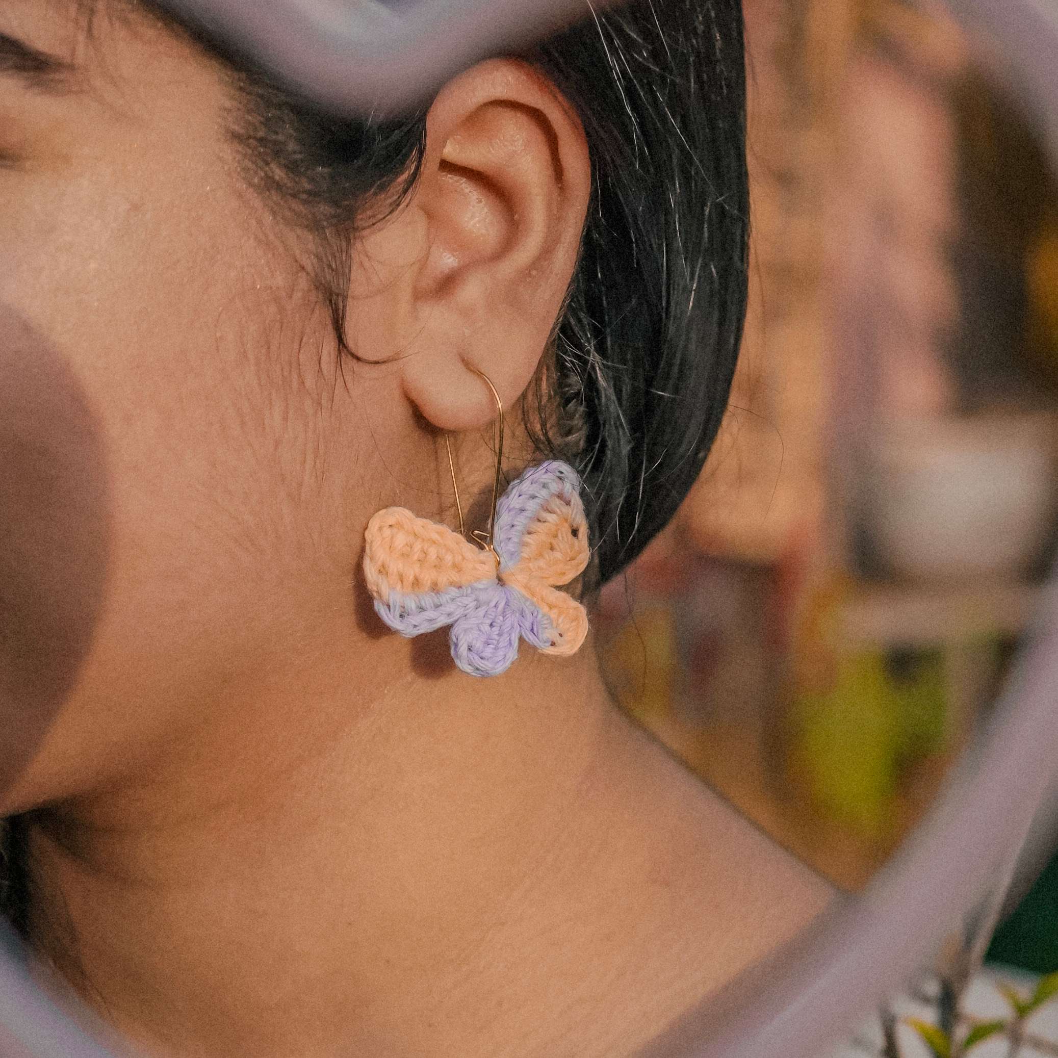  Model wearing the Peach Multi-Titli Earrings by A Handcrafted Gaatha, showcasing their playful charm