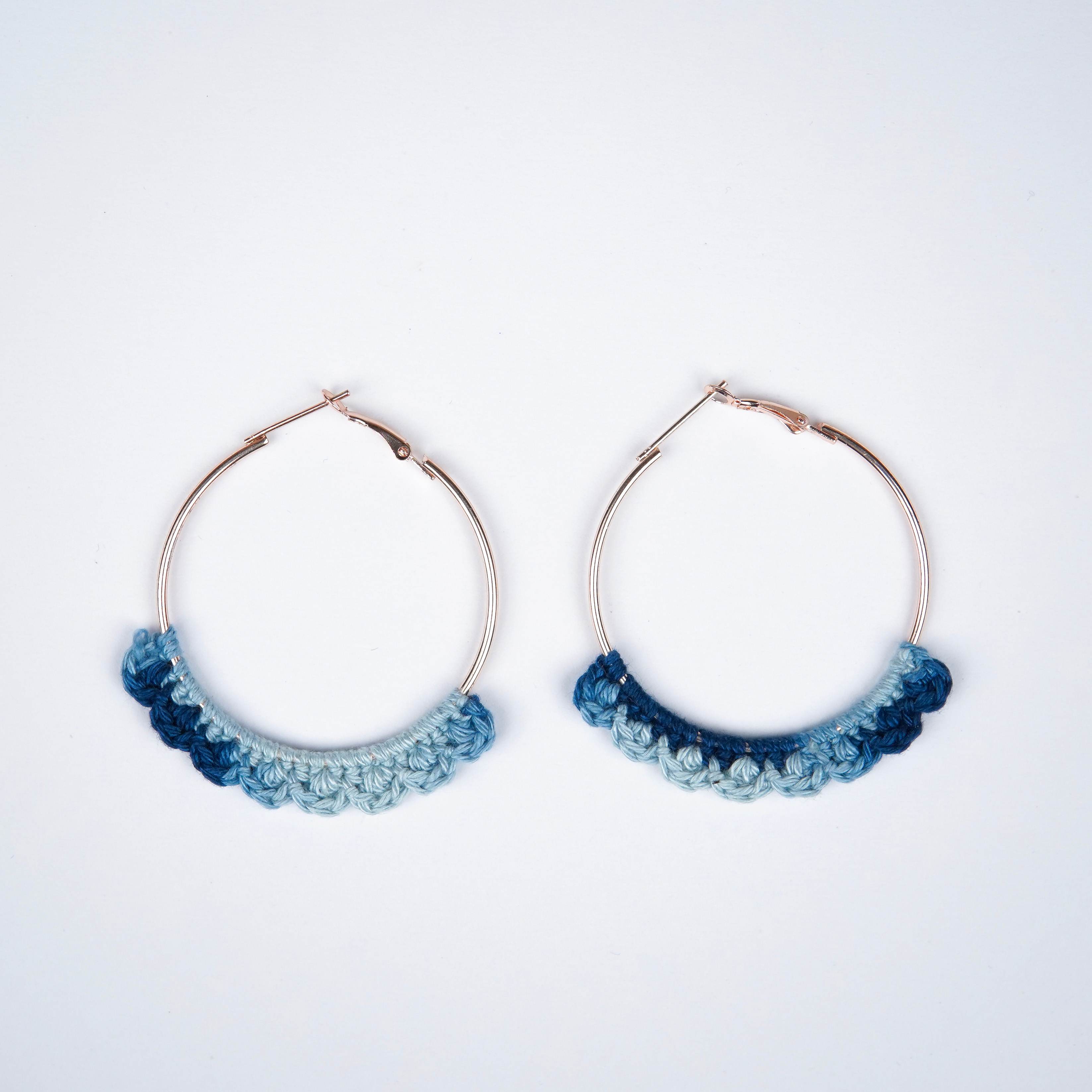 Close-up of AHG's Denim Blue Crochet Nazakat Hoops. Delicate crochet in a classic denim shade!
