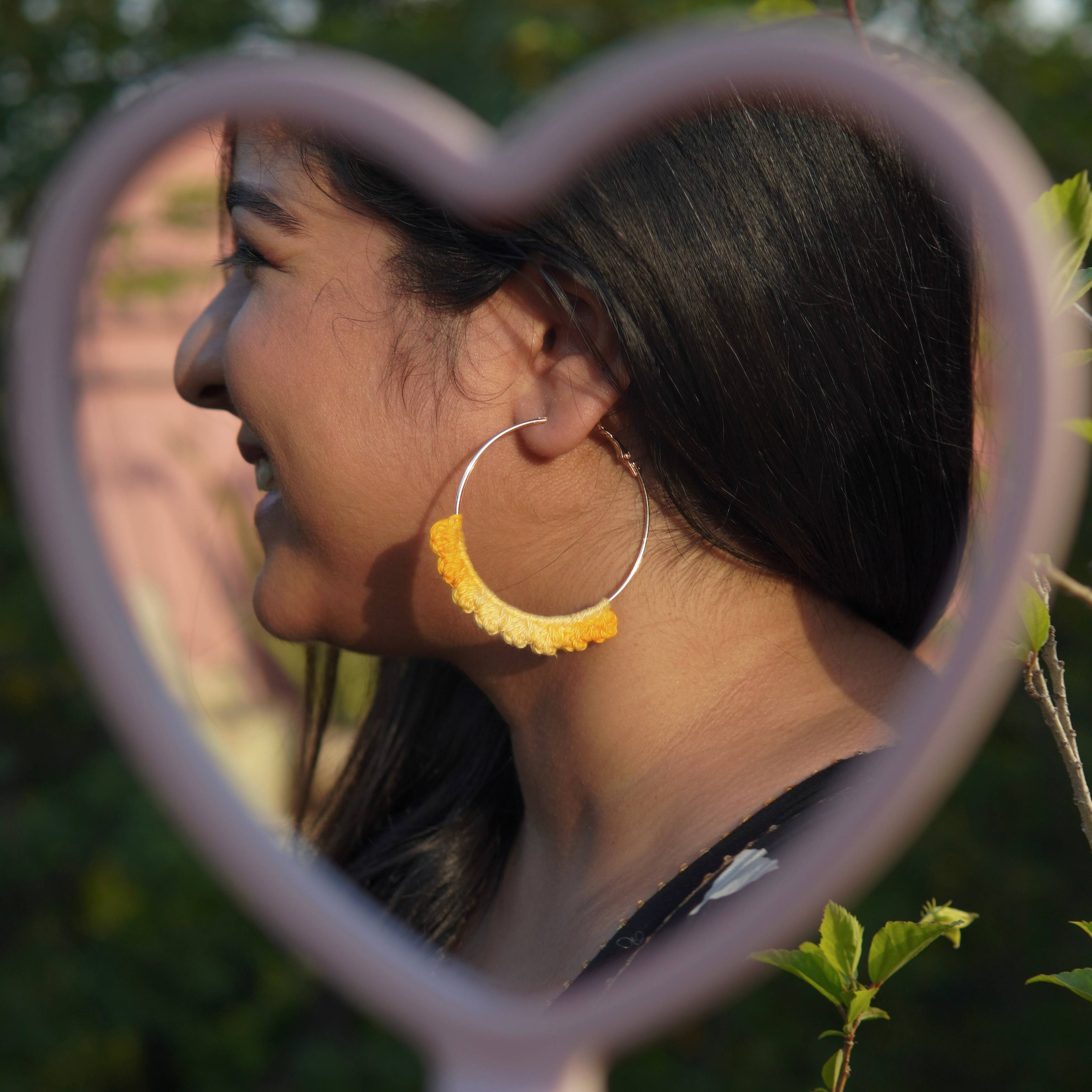 Model wearing the Yellow Crochet Nazakat Hoops by AHG. Perfect for everyday style!
