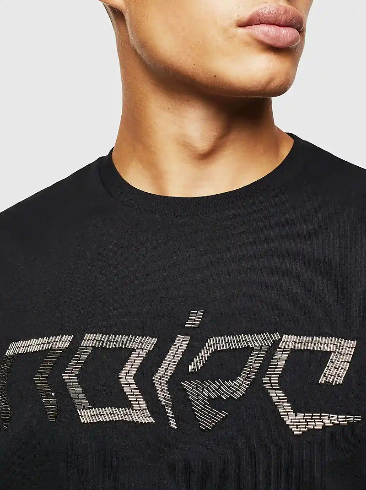 Black T-shirt with beaded Noize lettering