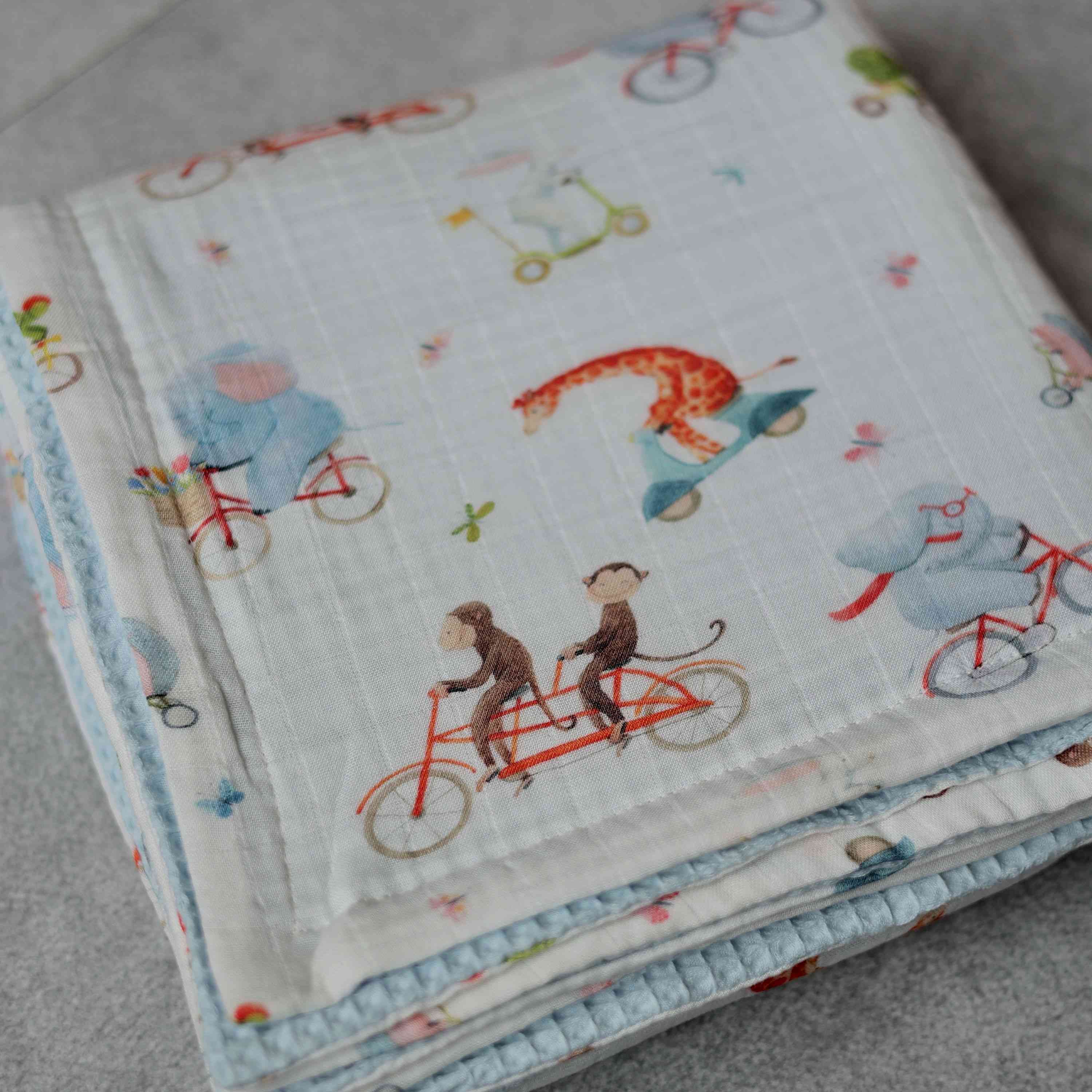 Playful Pedal Pals Muslin Blanket