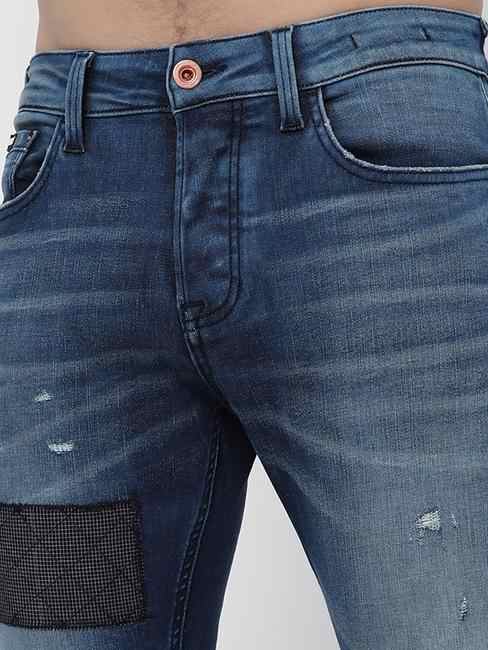 Norton Mid-Wash Distressed Tapered Jeans