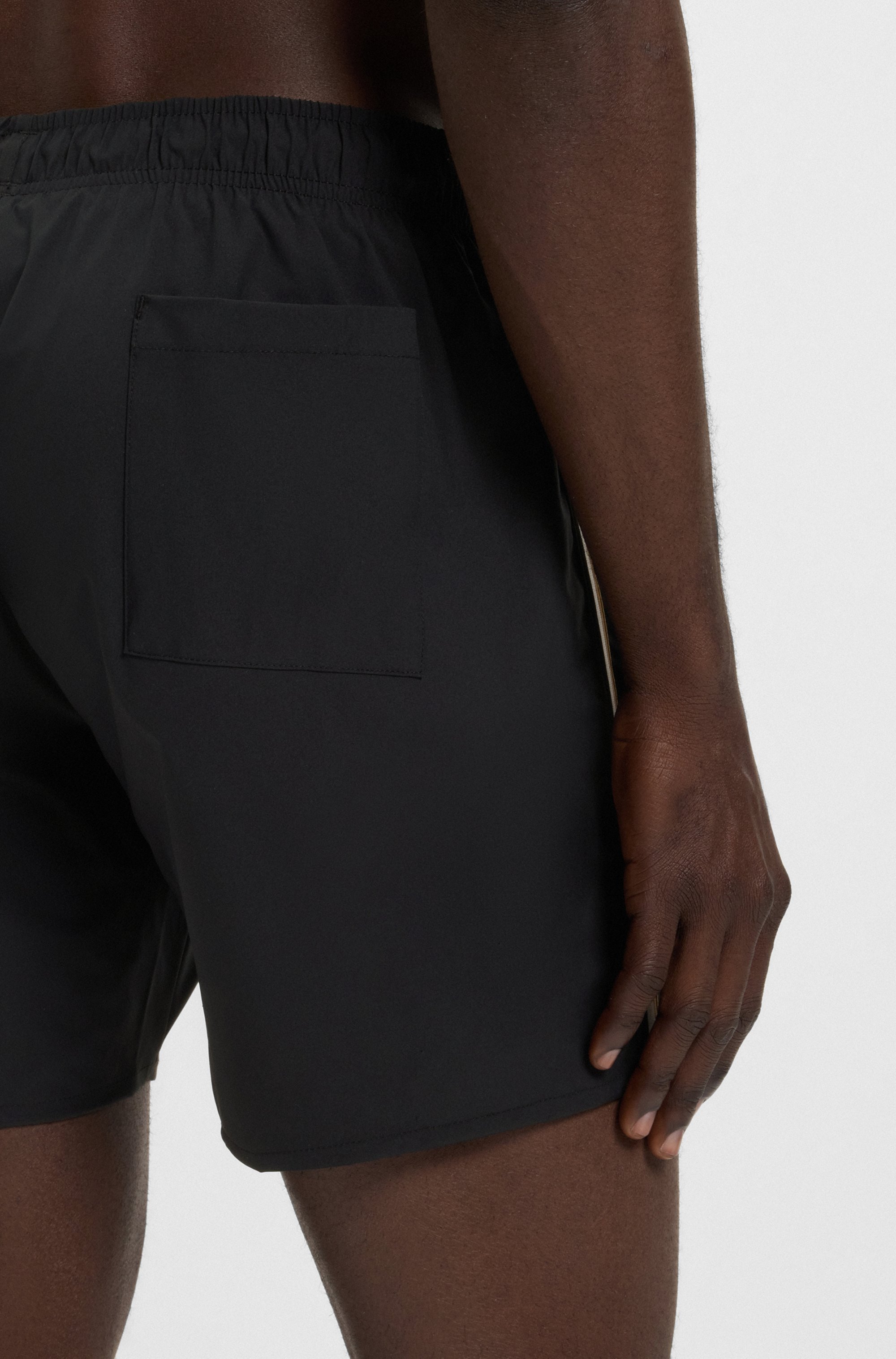 Swim shorts with signature stripe and logo