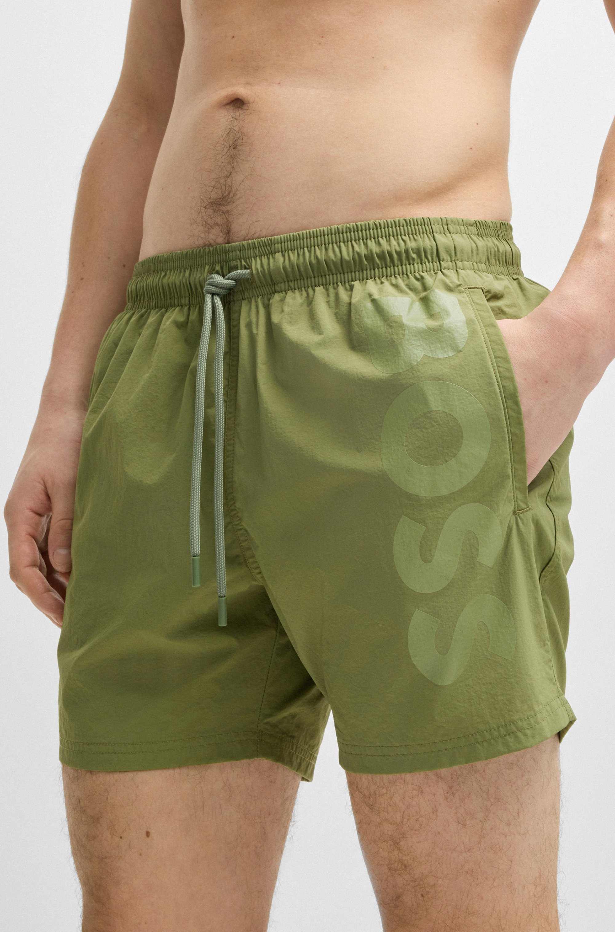 Swim shorts with vertical logo print
