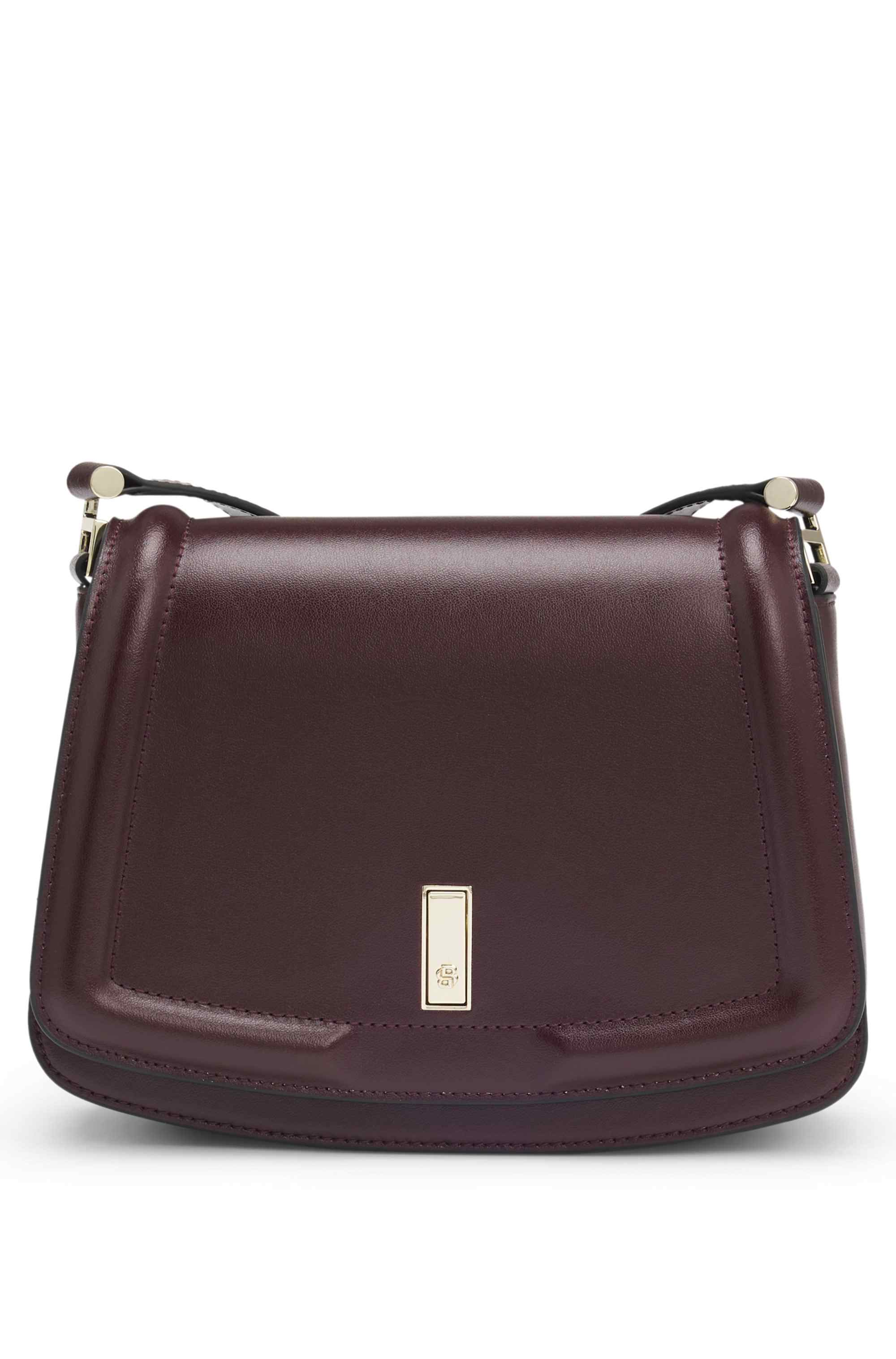 Leather saddle bag with signature hardware and monogram