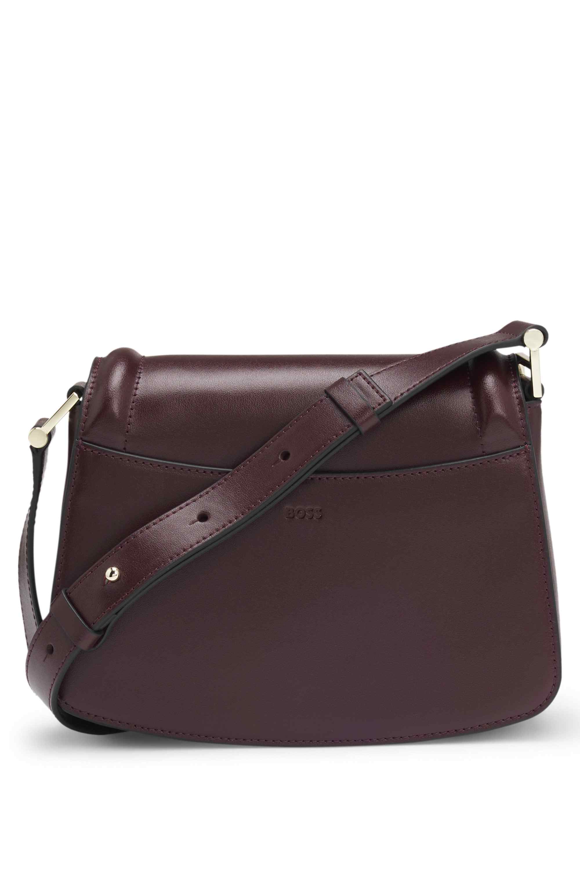 Leather saddle bag with signature hardware and monogram