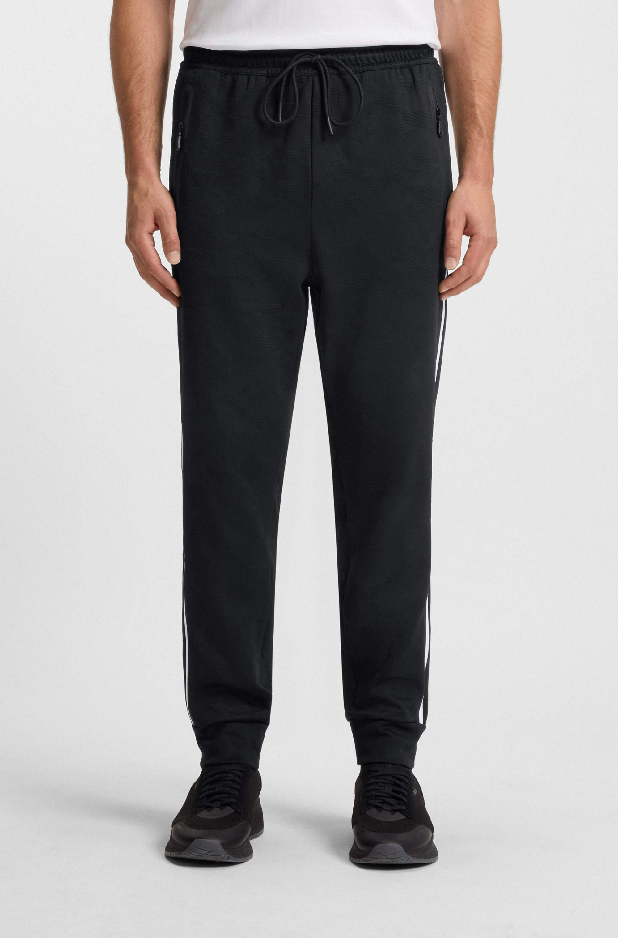 Relaxed-fit tracksuit bottoms with jacquard-woven circles