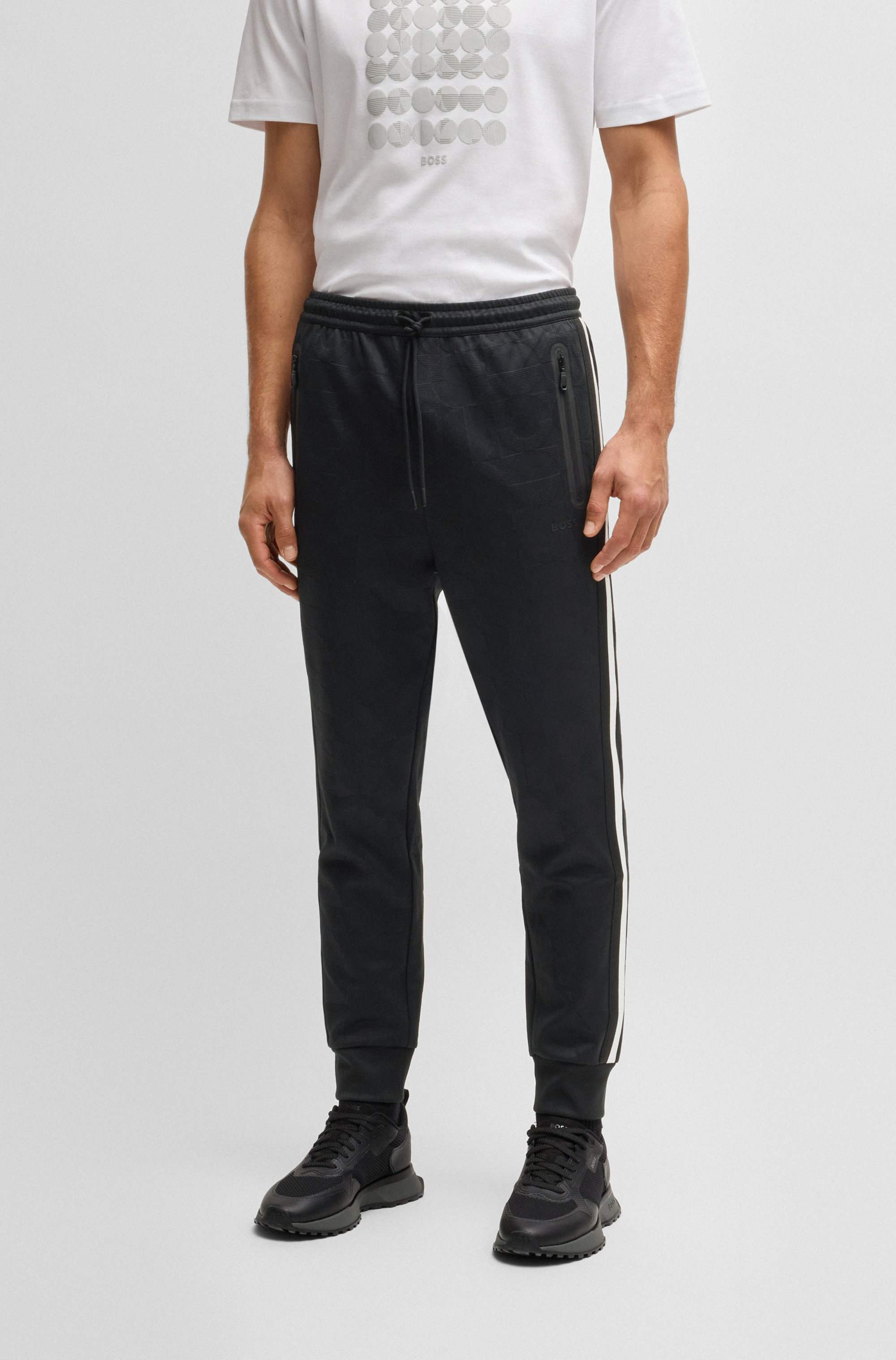 Relaxed-fit tracksuit bottoms with jacquard-woven circles