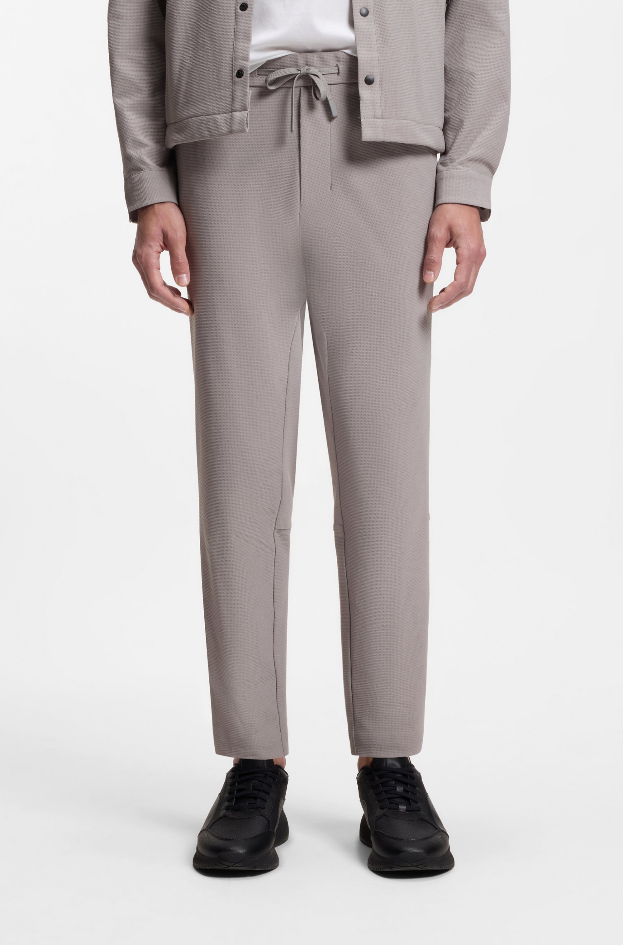 Tapered-fit trousers in waffle-structured stretch fabric