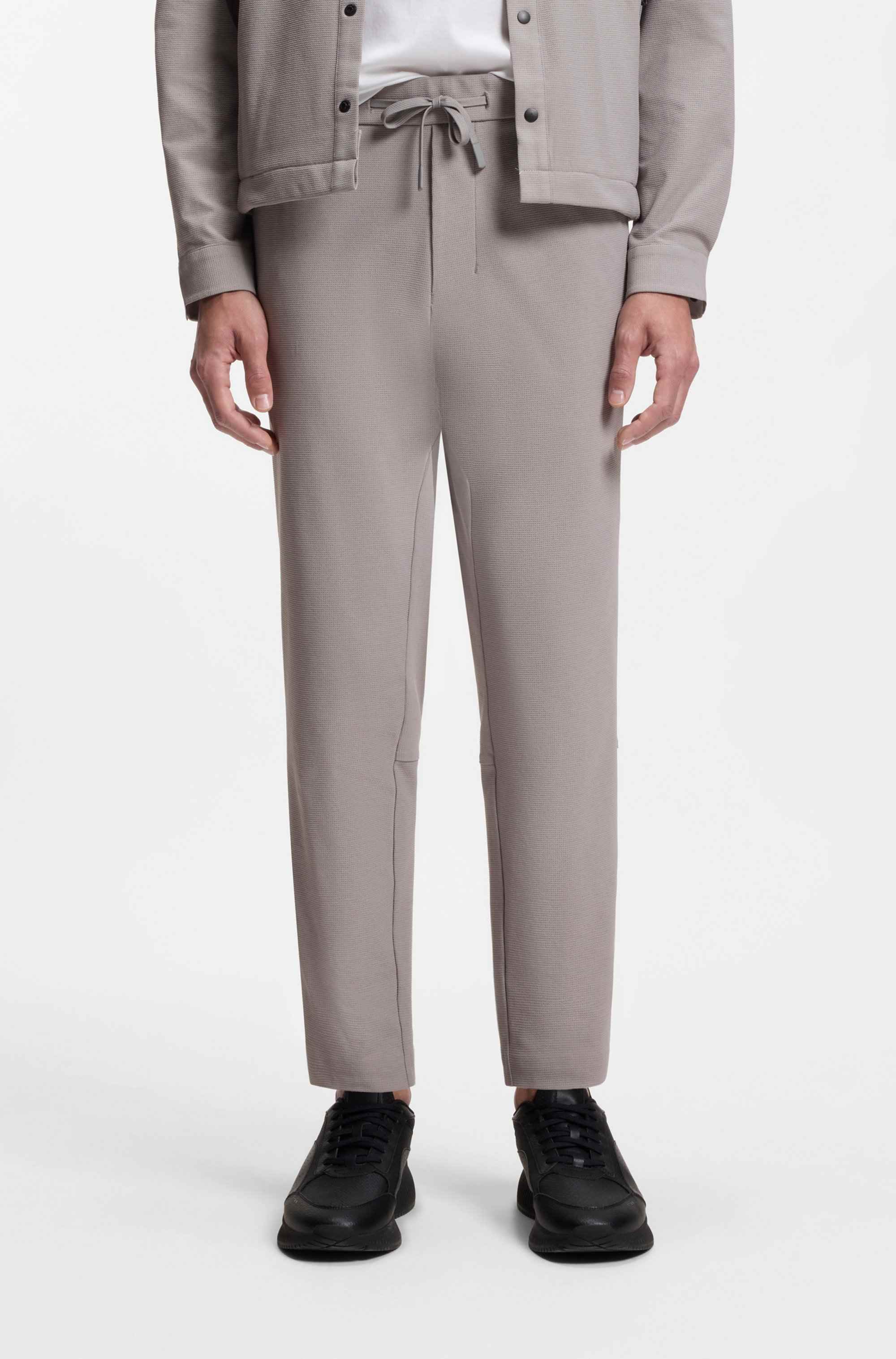 Tapered-fit trousers in waffle-structured stretch fabric