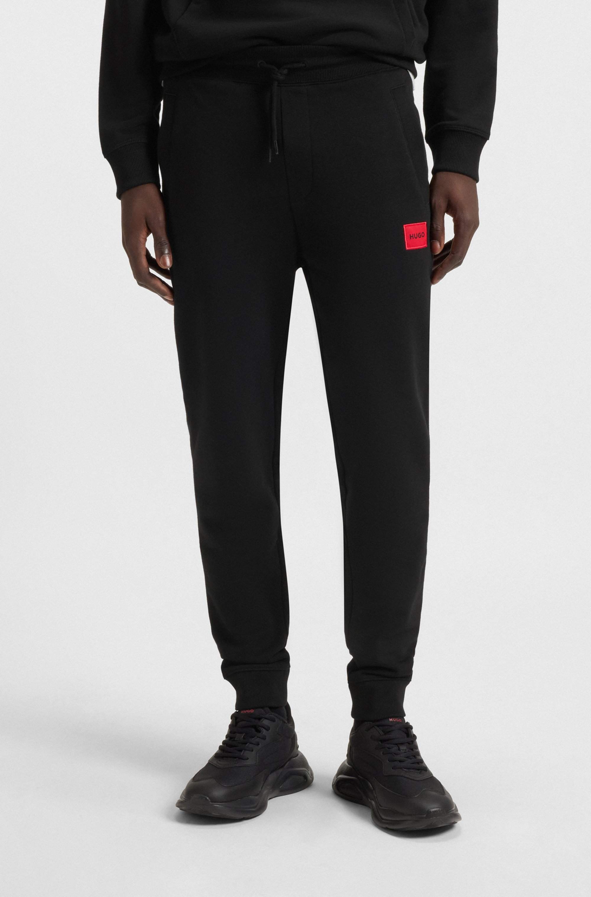 Cotton-terry tracksuit bottoms with red logo label