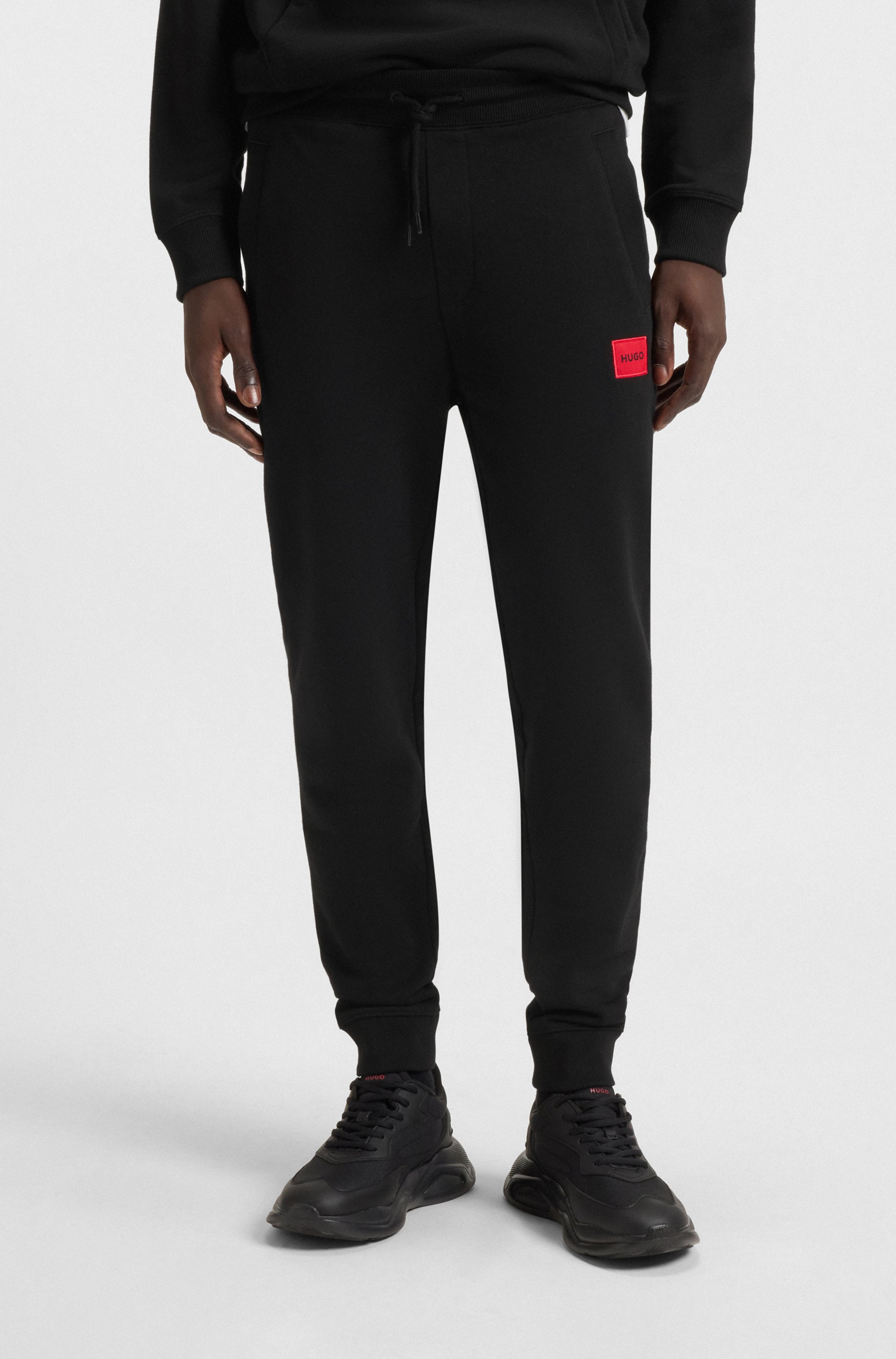 Cotton-terry tracksuit bottoms with red logo label