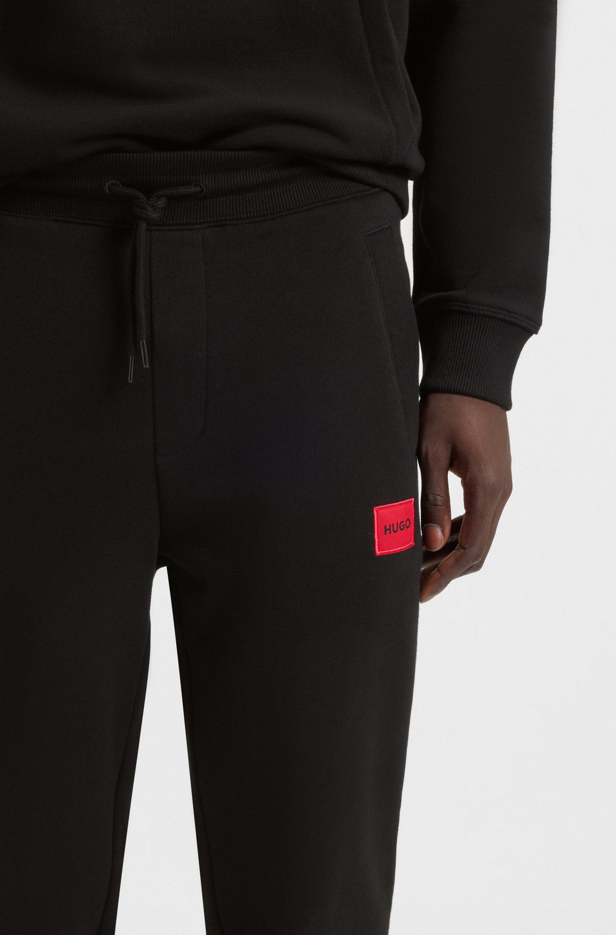 Cotton-terry tracksuit bottoms with red logo label