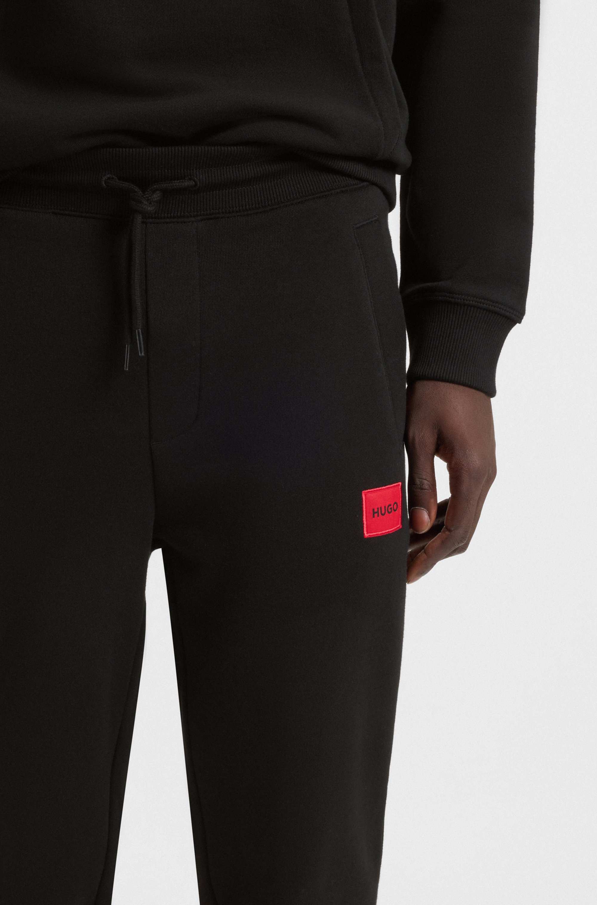 Cotton-terry tracksuit bottoms with red logo label